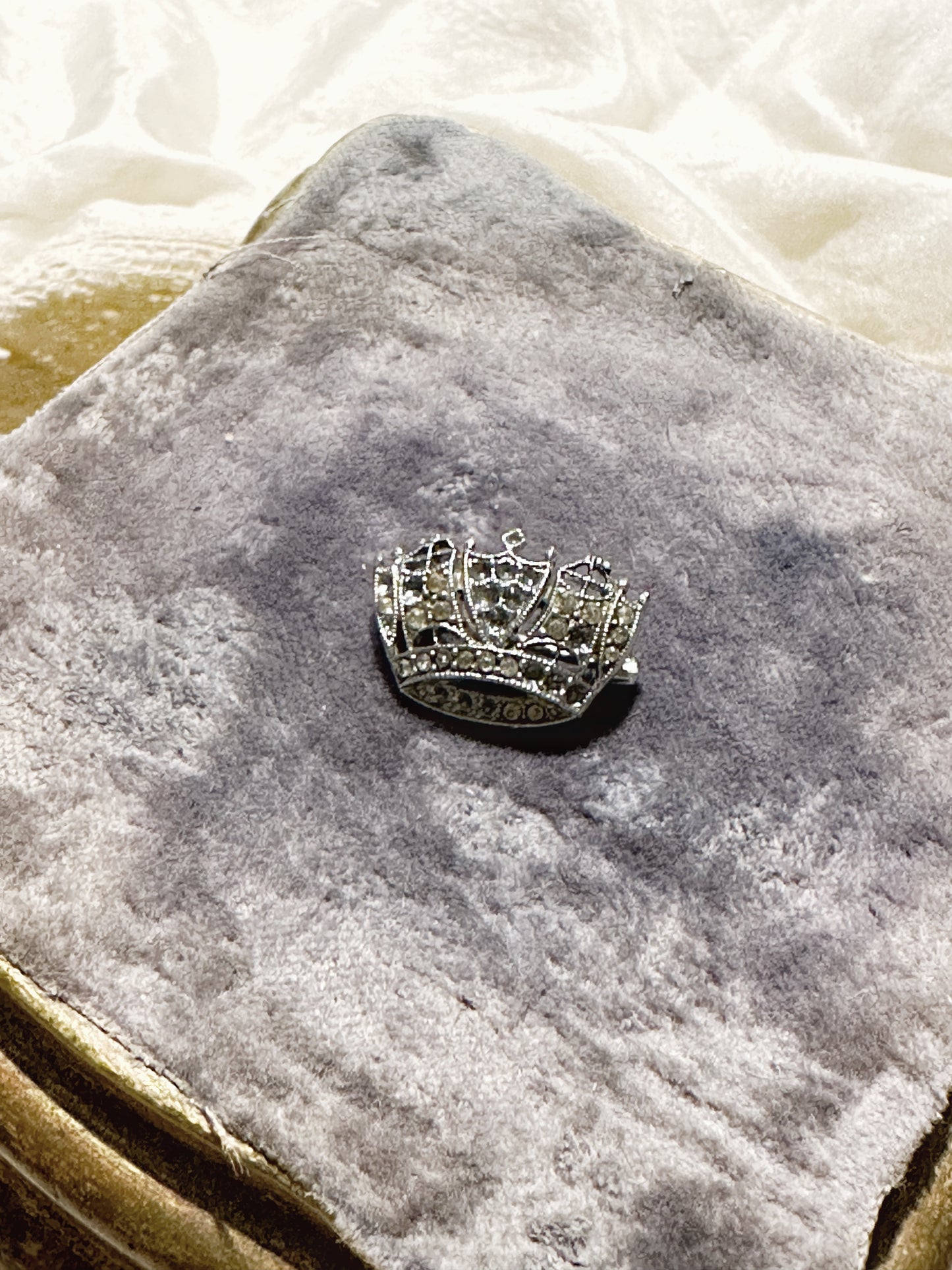 A tiny diamanté crown brooch