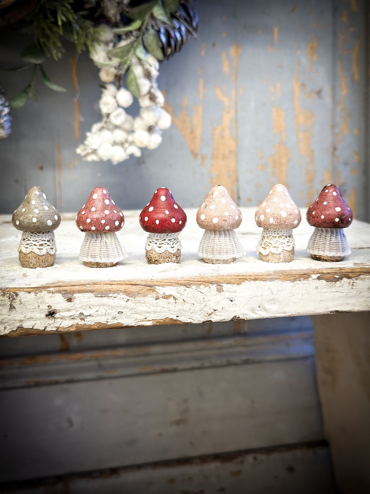 A wooden hand painted and trimmed Christmas village toadstool small pointy one