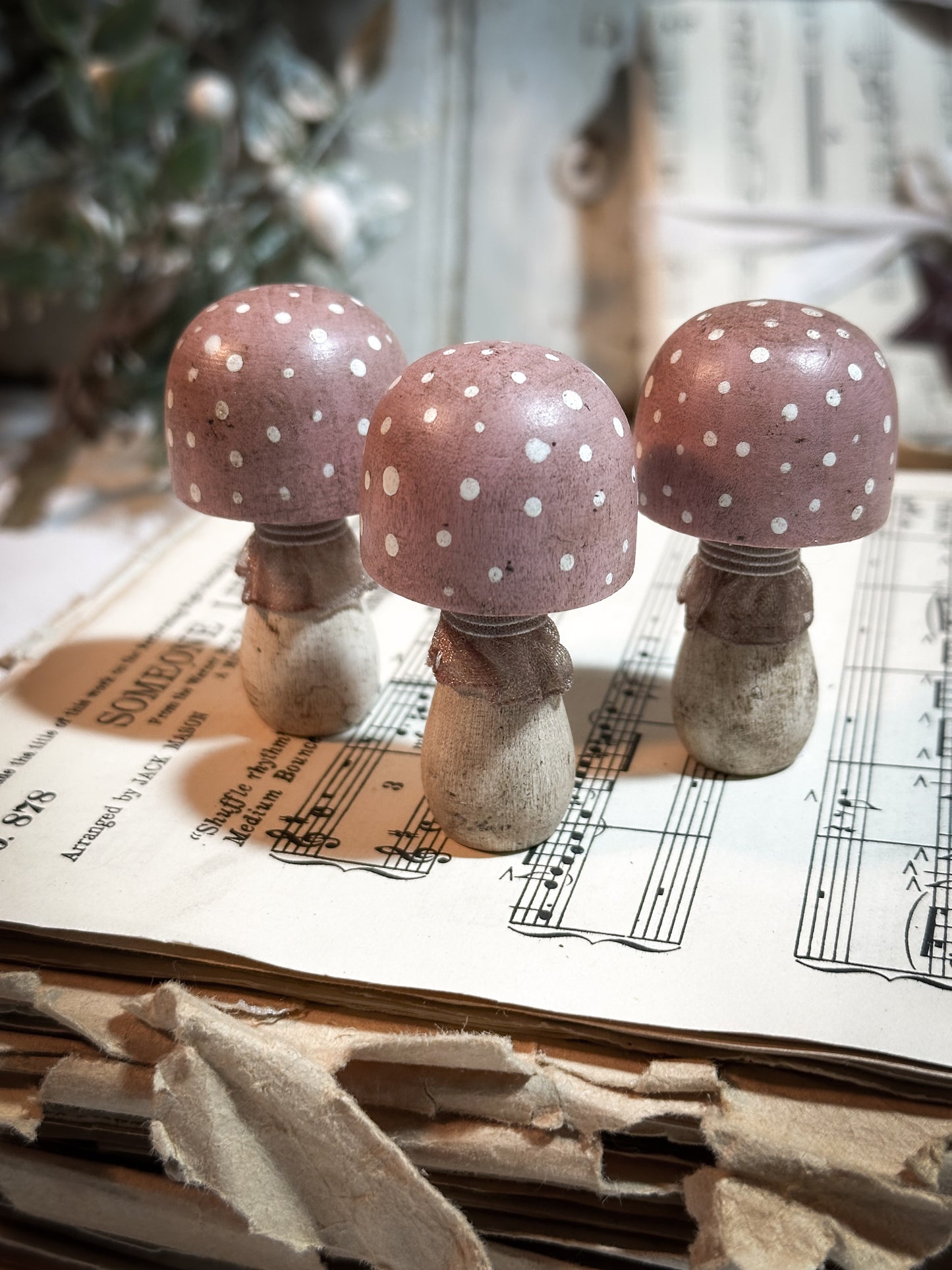 A wooden hand painted and trimmed Christmas village toadstool