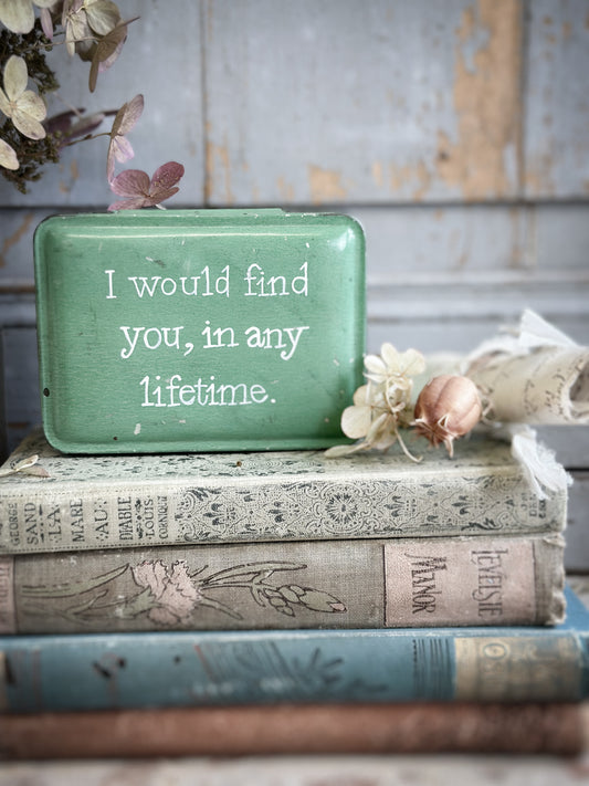 A Vintage Tin With A Hand Painted Quote