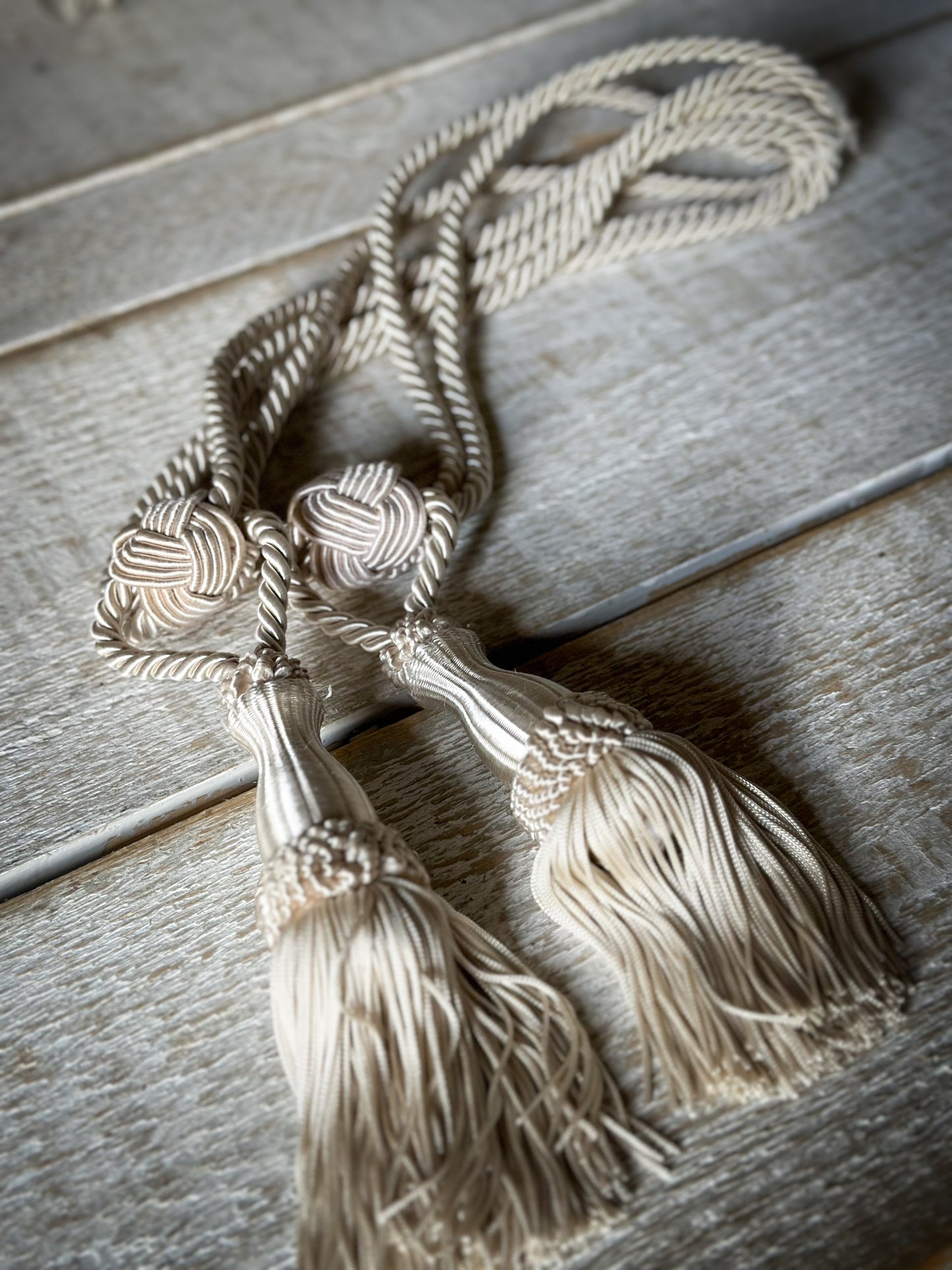 A pair of pretty vintage ivory curtain tie backs