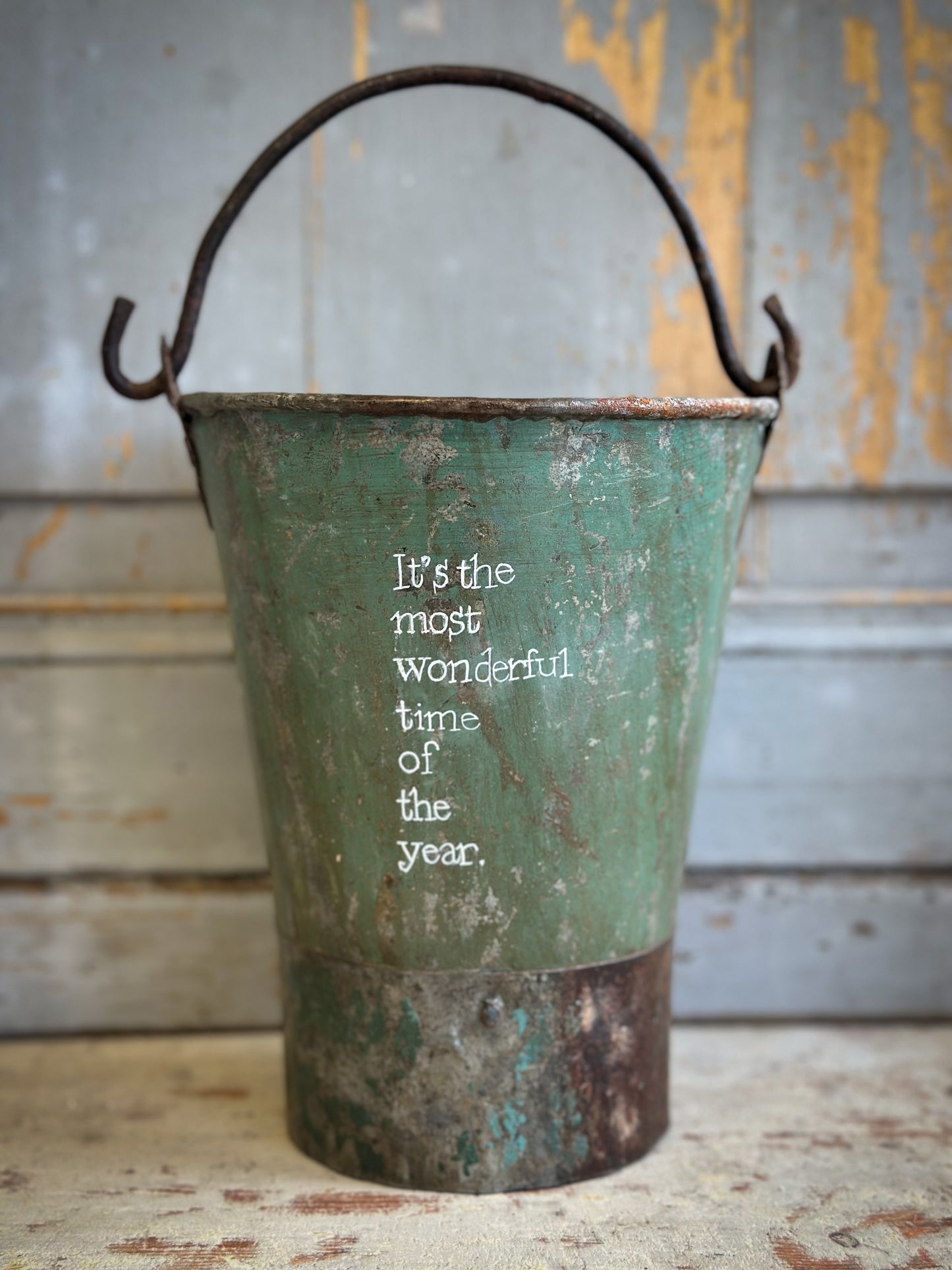 A Recycled Metal Mini Christmas Tree Bucket With A Hand Painted Quote