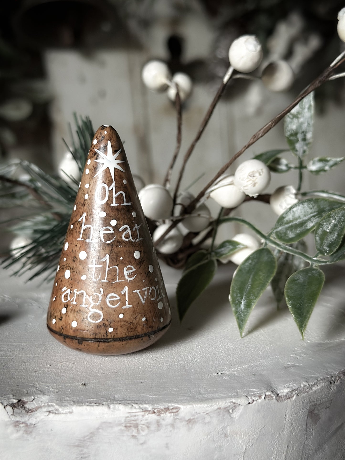 A hand painted quote on a lignum vitae wood plumber’s turnpin with a Christmas quote