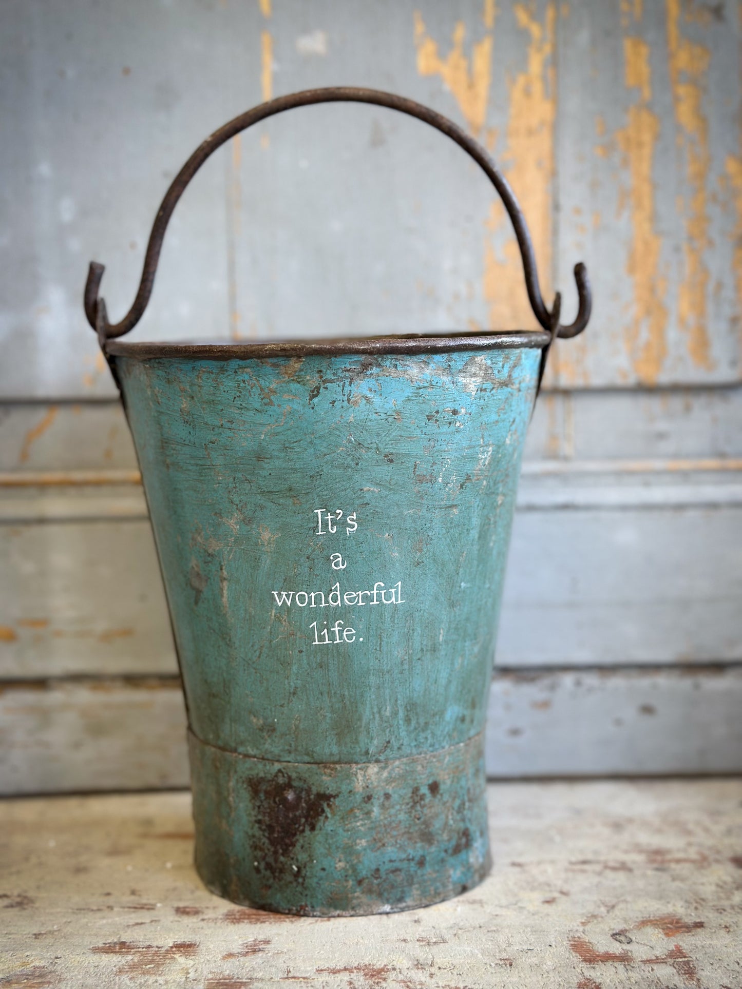 A Recycled Metal Mini Christmas Tree Bucket With A Hand Painted Quote