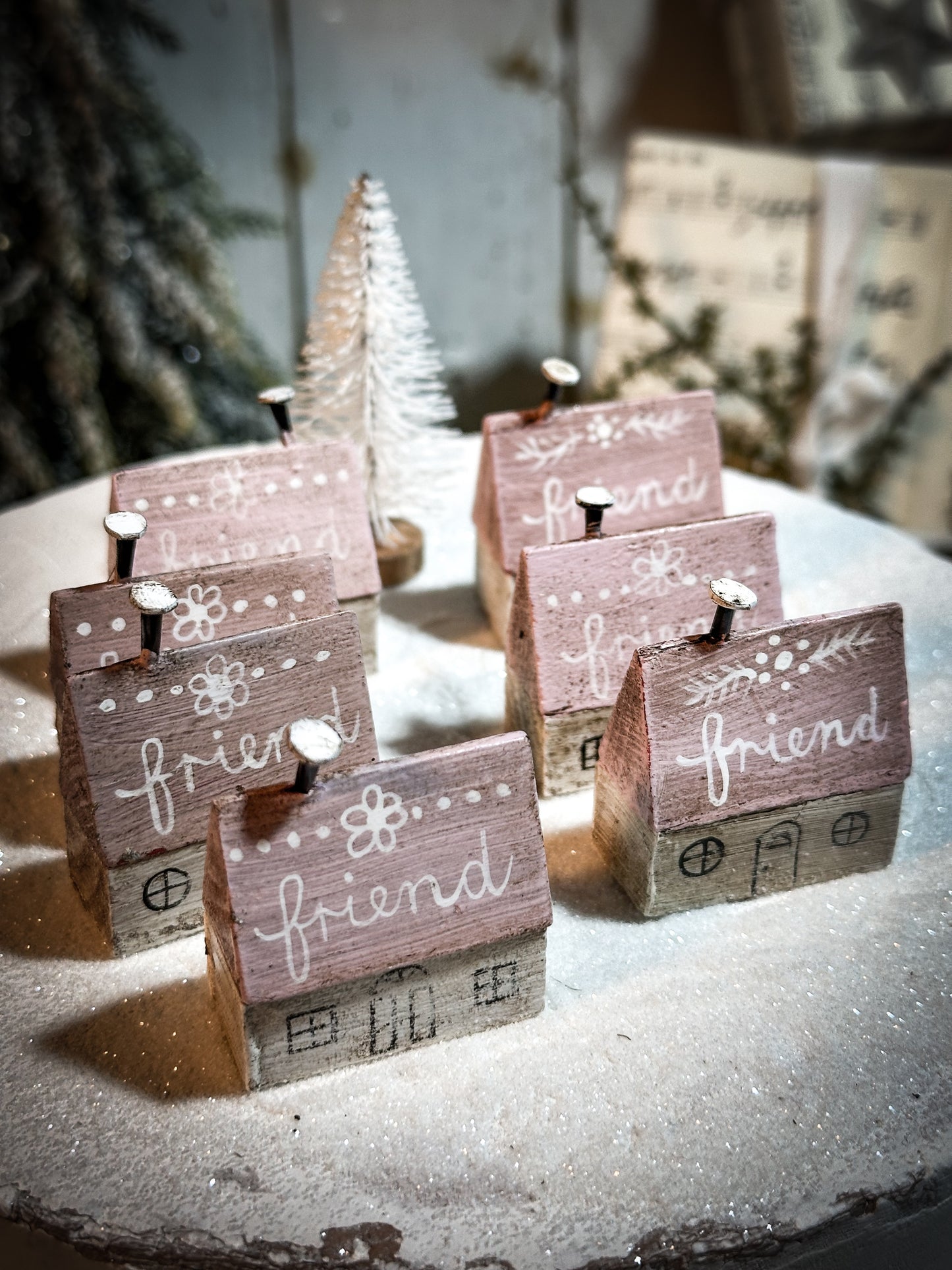 A pretty vintage German Erzgebirge Putz wooden village house painted with a Christmas quote