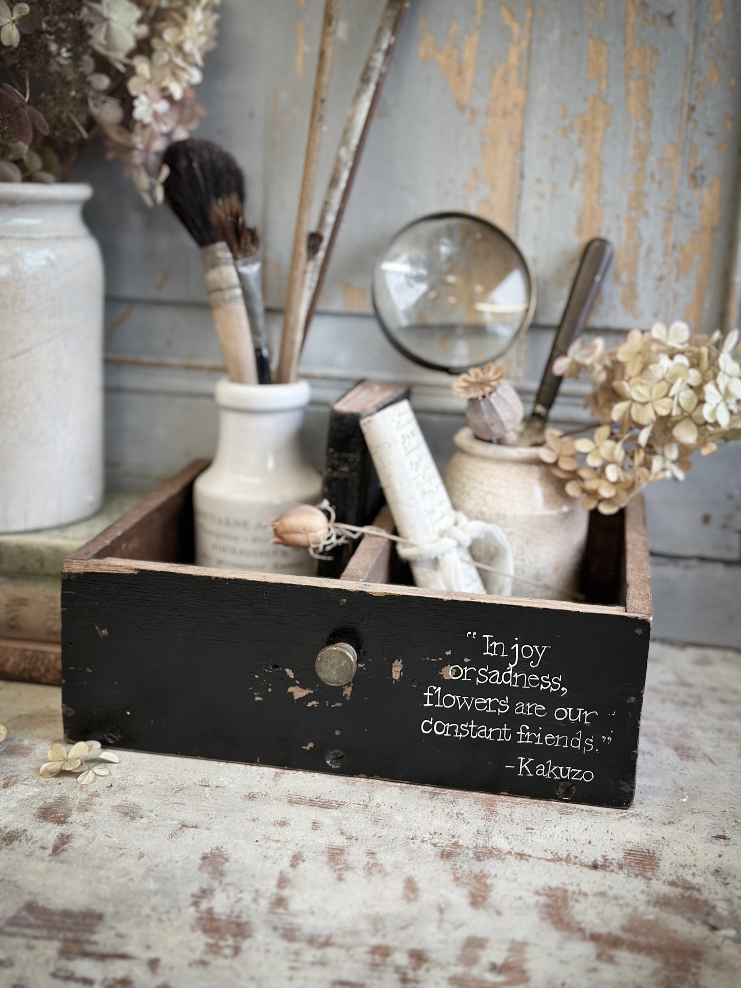 A Vintage Wooden Drawer With Hand Painted Quote
