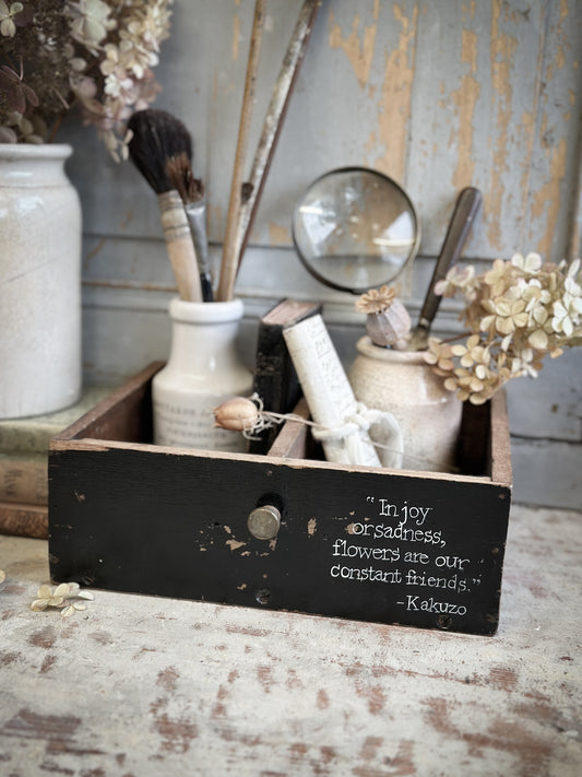 A Vintage Wooden Drawer With Hand Painted Quote