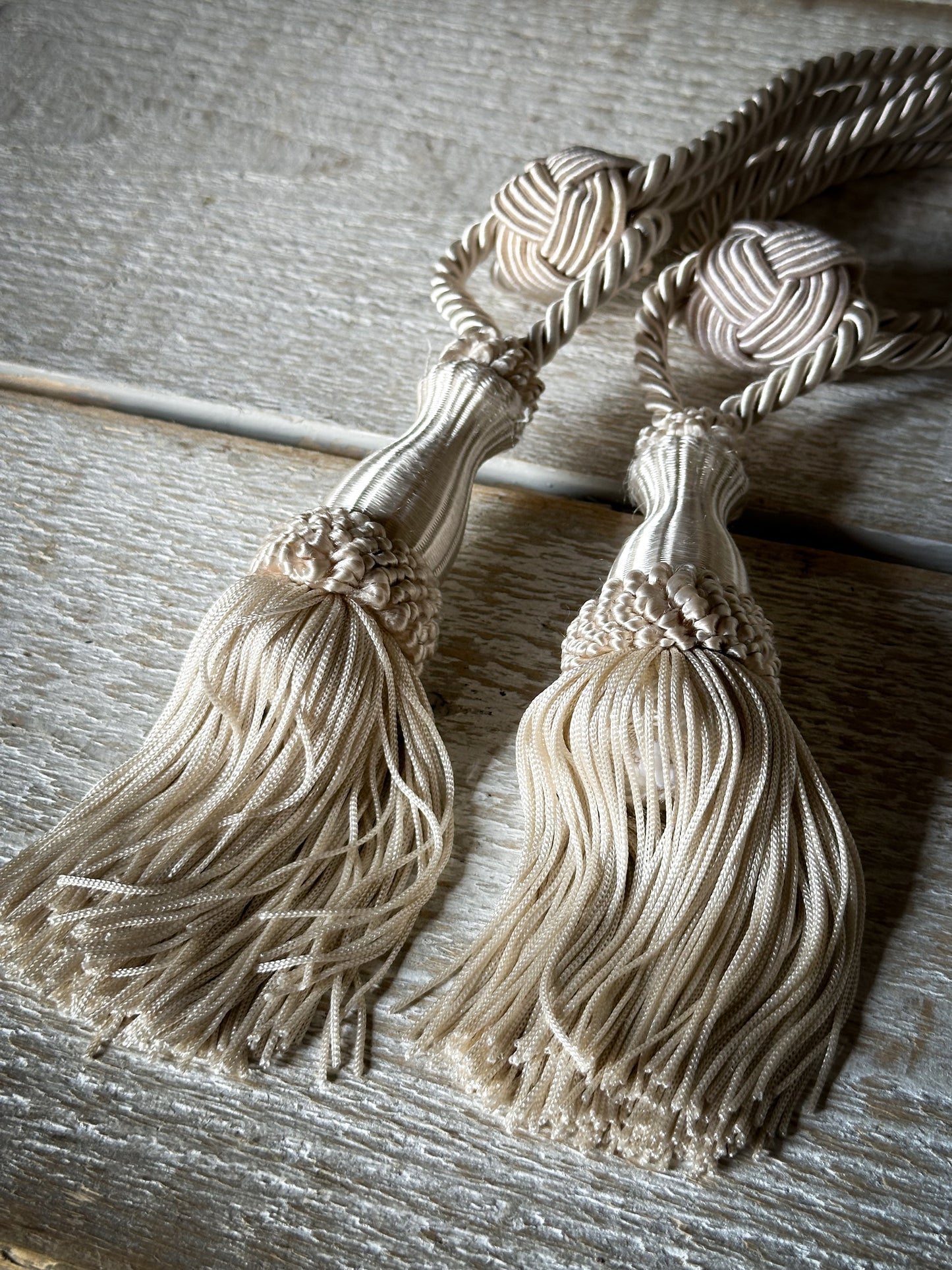 A pair of pretty vintage ivory curtain tie backs