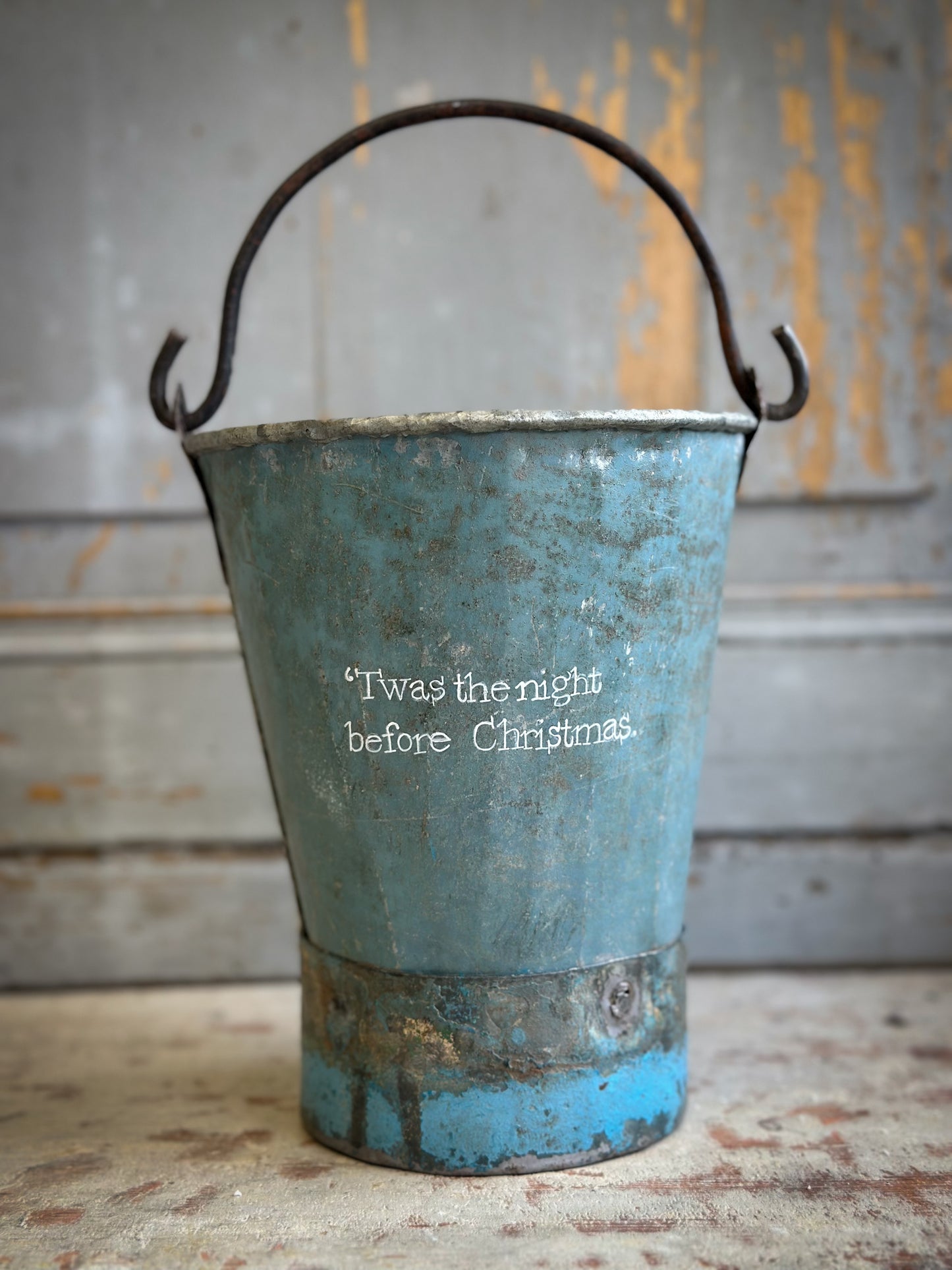 A Recycled Metal Mini Christmas Tree Bucket With A Hand Painted Quote