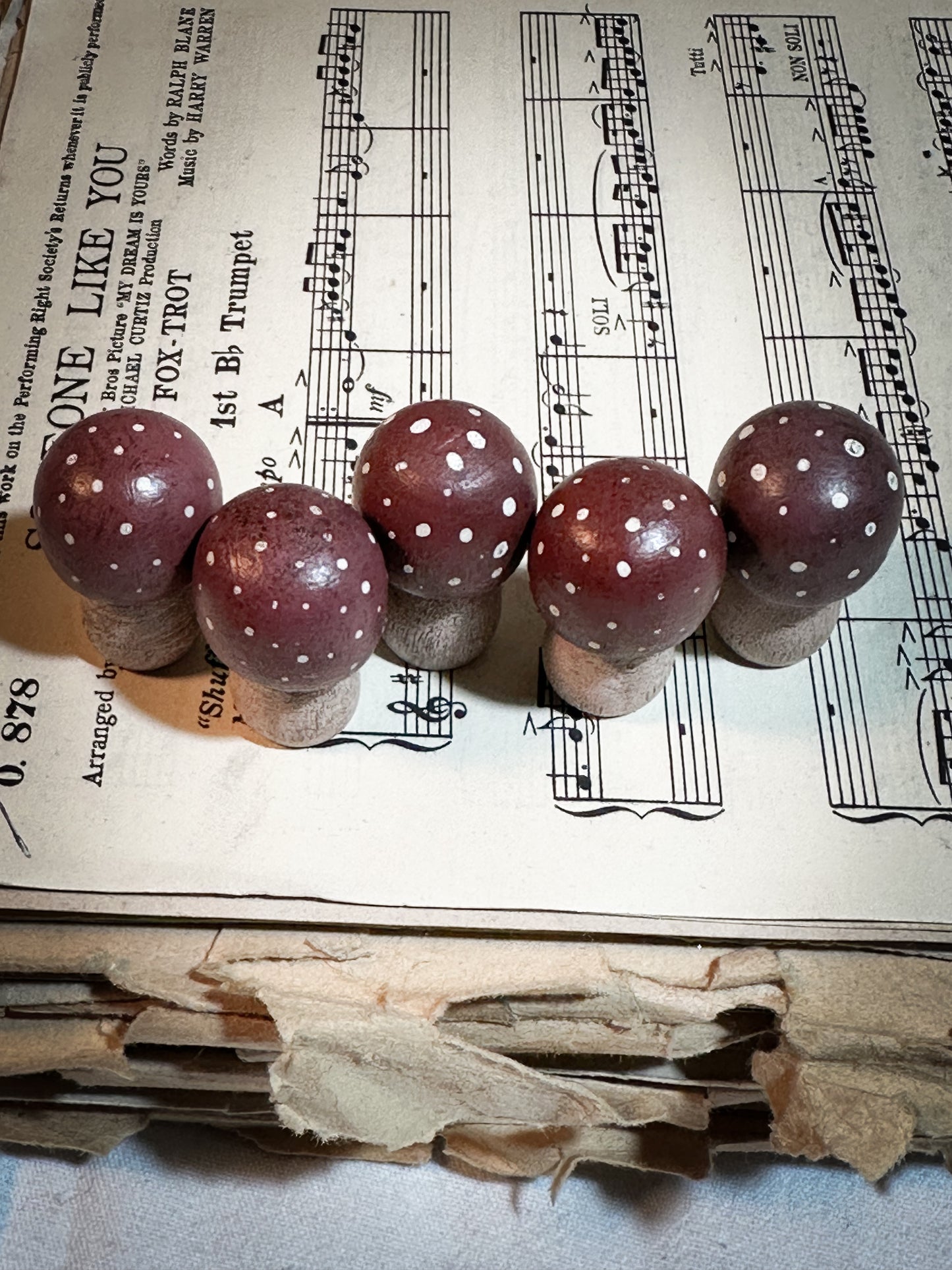 A wooden hand painted Christmas village toadstool