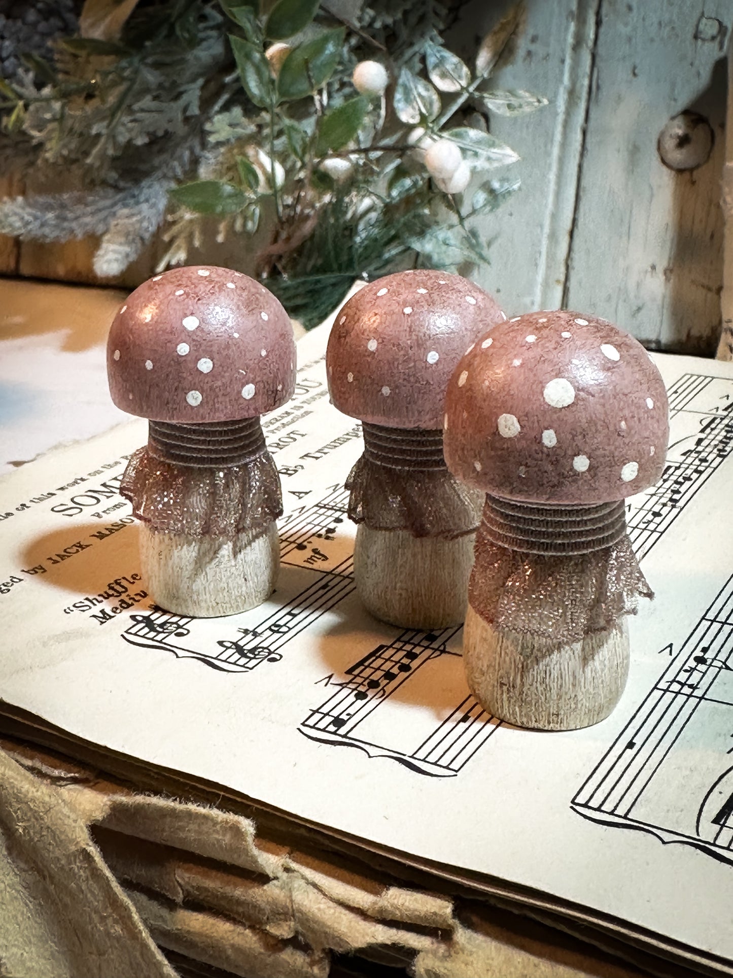 A wooden hand painted and trimmed Christmas village toadstool