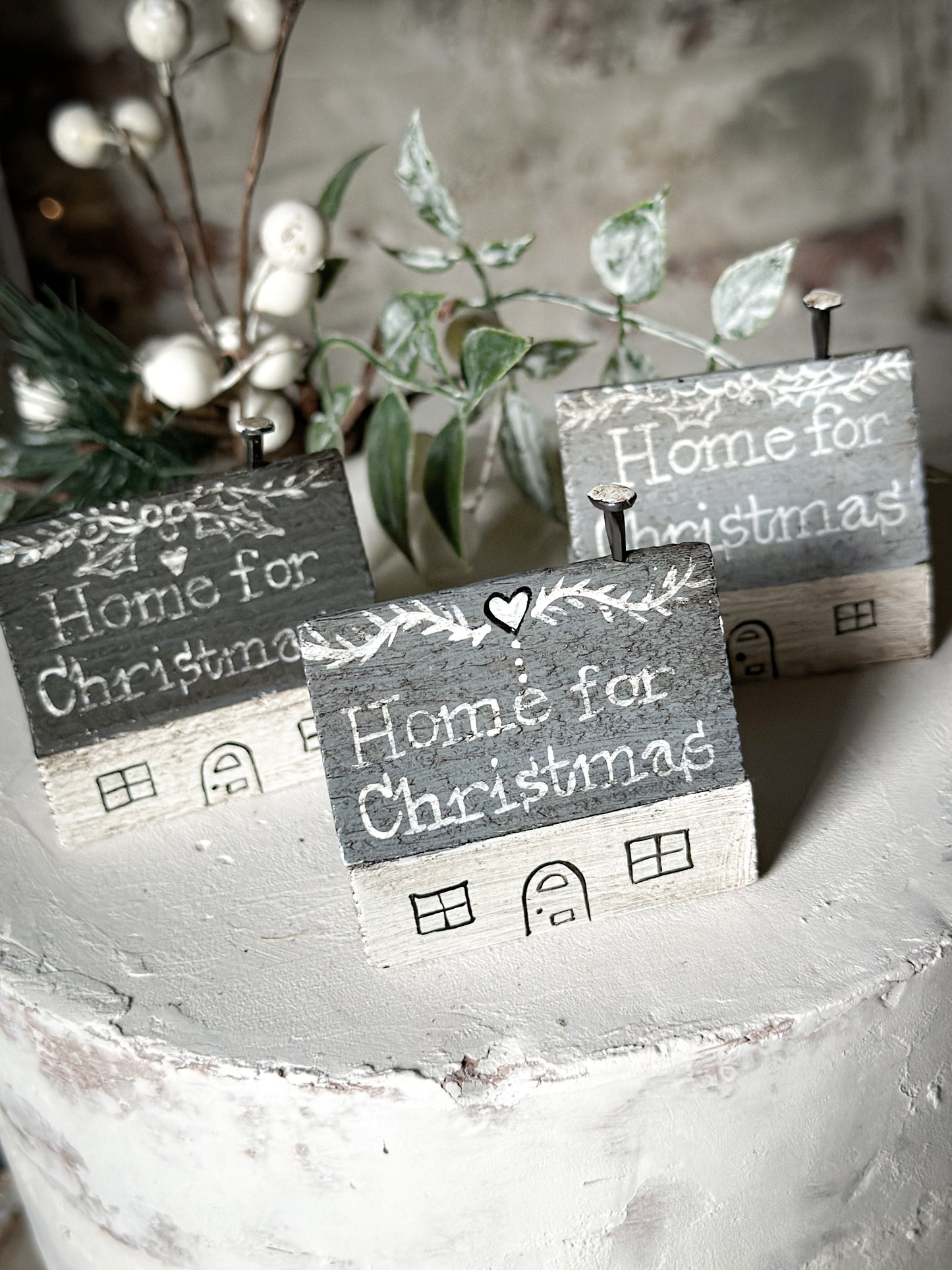 A pretty vintage German Erzgebirge Putz wooden village house painted with a Christmas quote