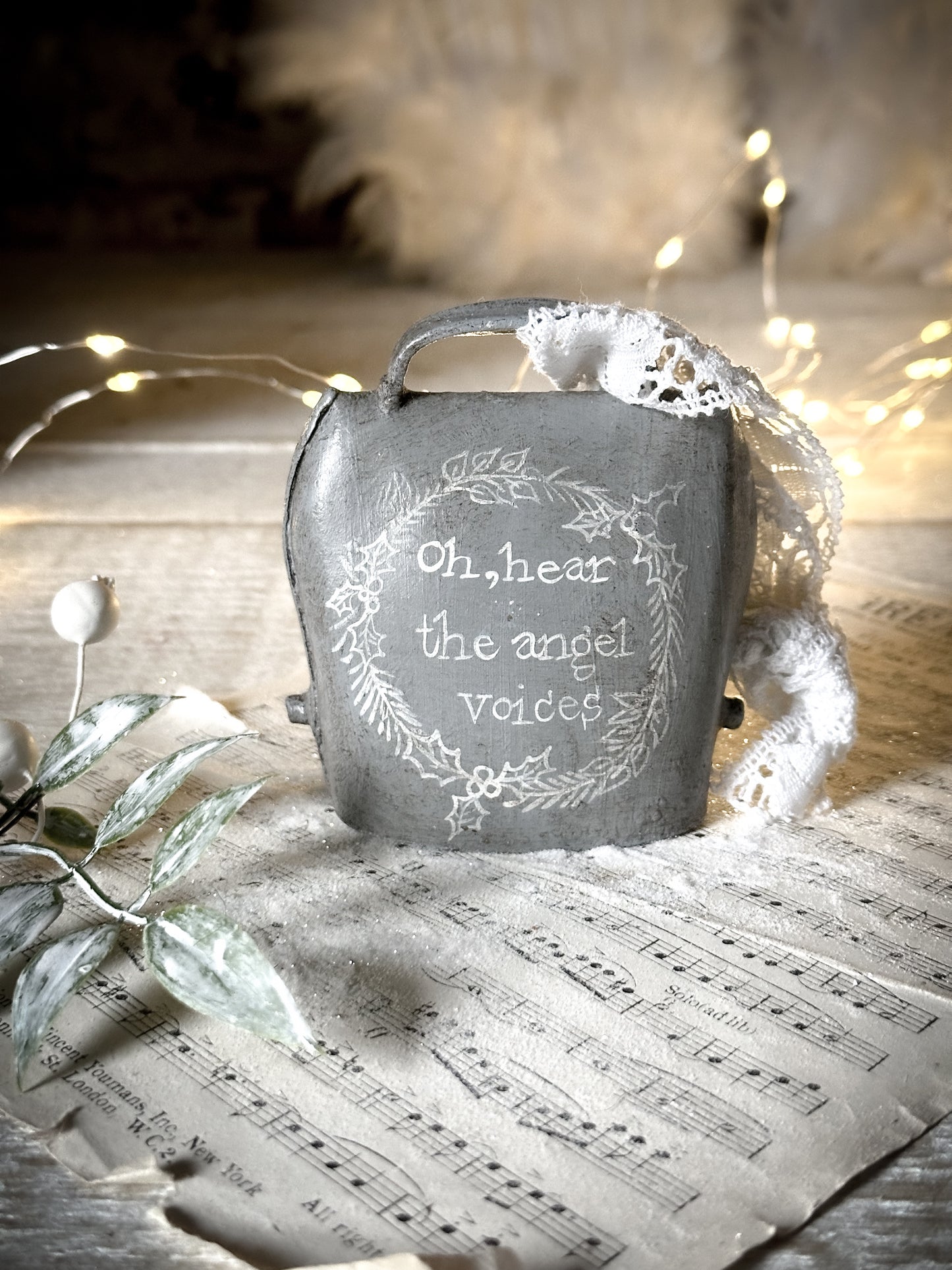 A vintage bell with a hand painted quote