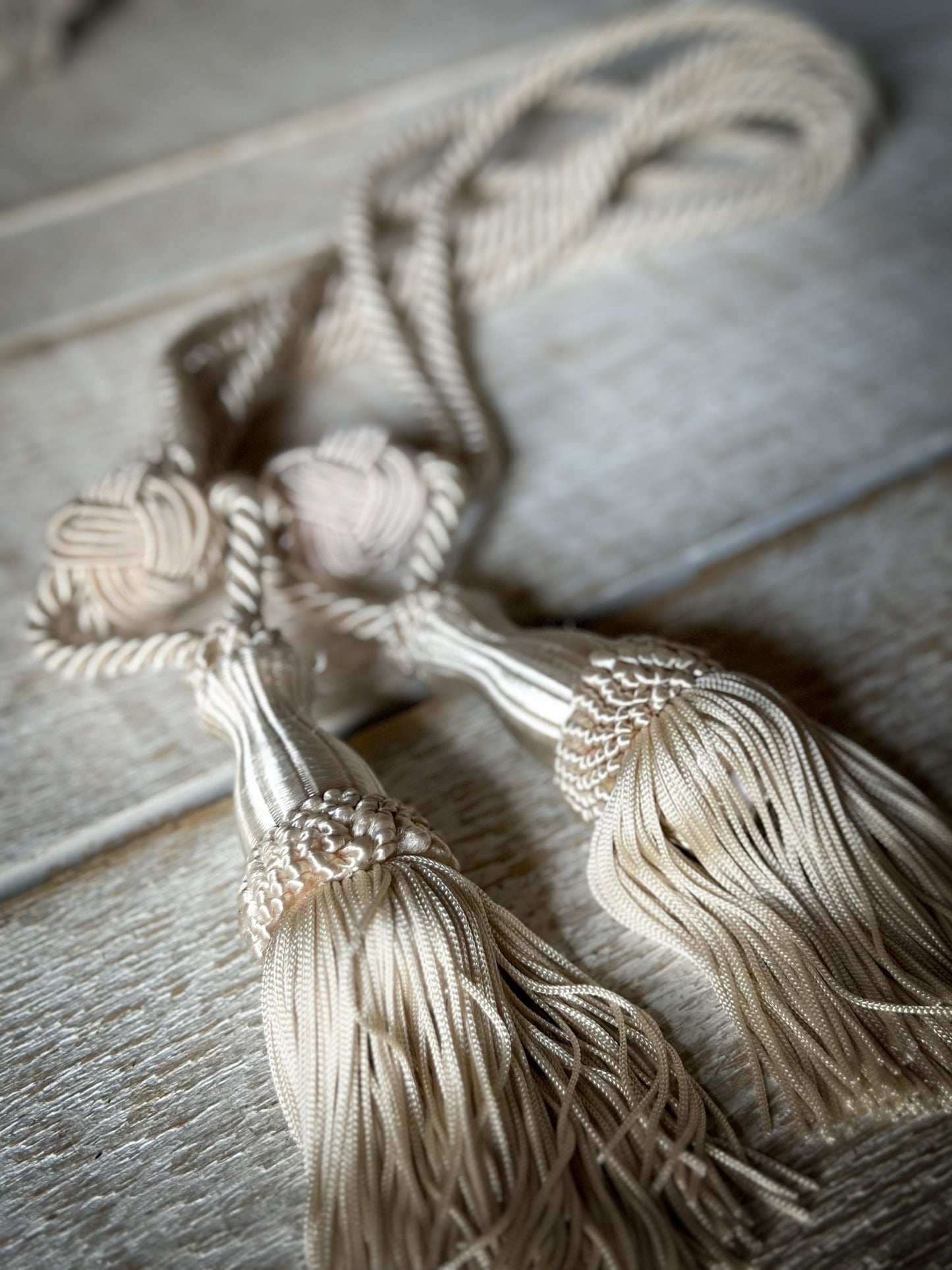 A pair of pretty vintage ivory curtain tie backs