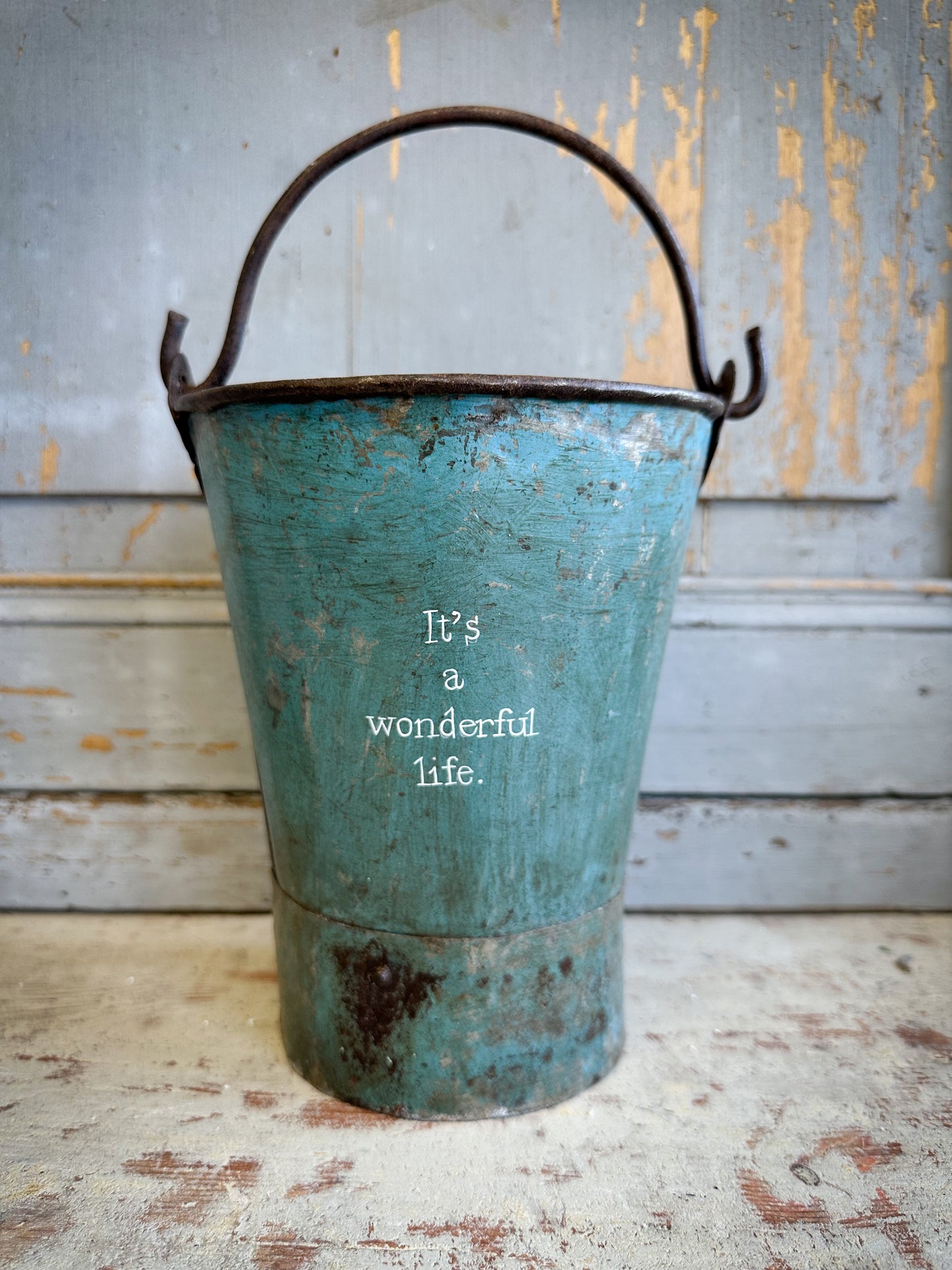 A Recycled Metal Mini Christmas Tree Bucket With A Hand Painted Quote