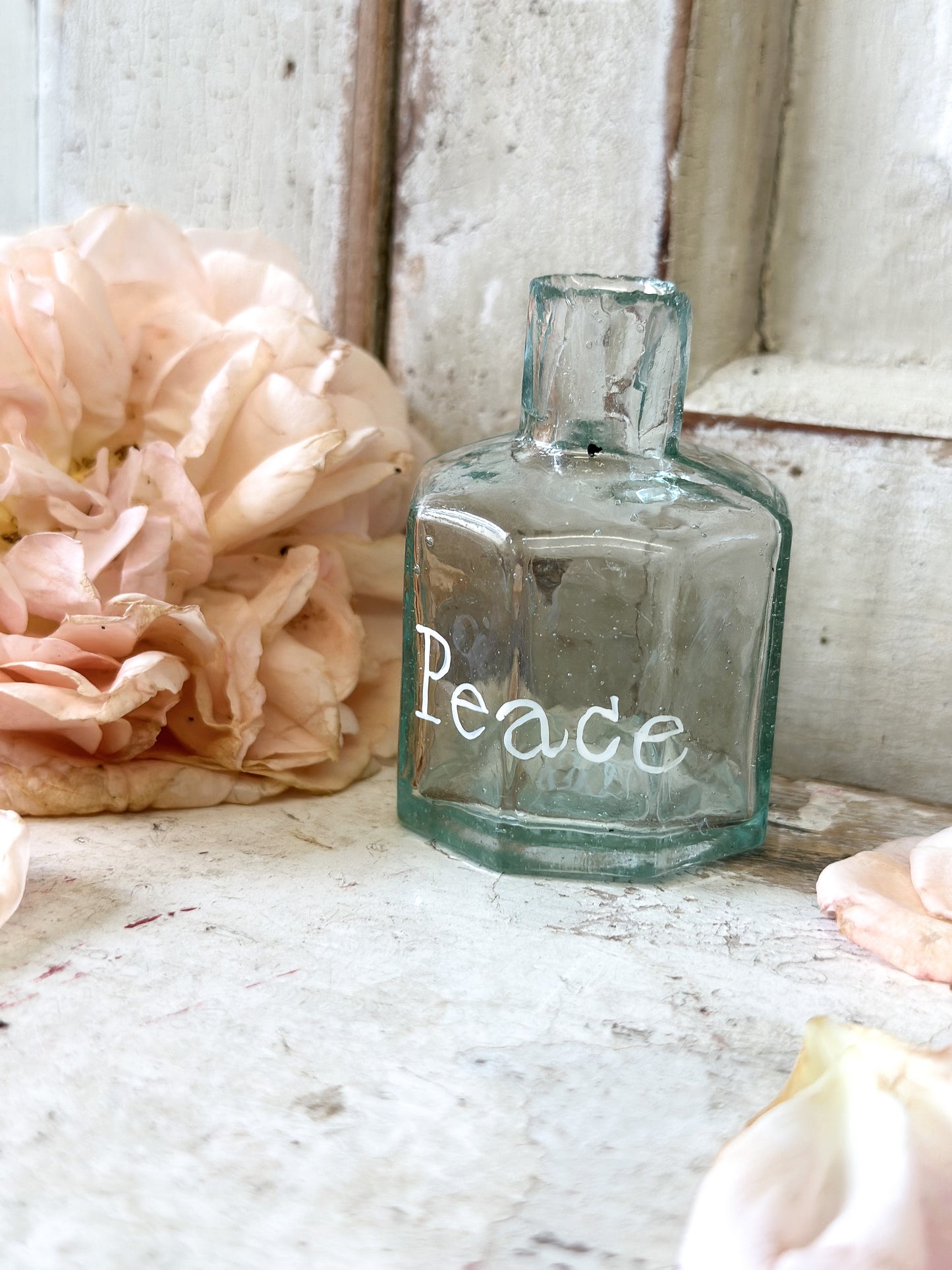 A beautiful Victorian bottle with a hand painted quote “Peace”