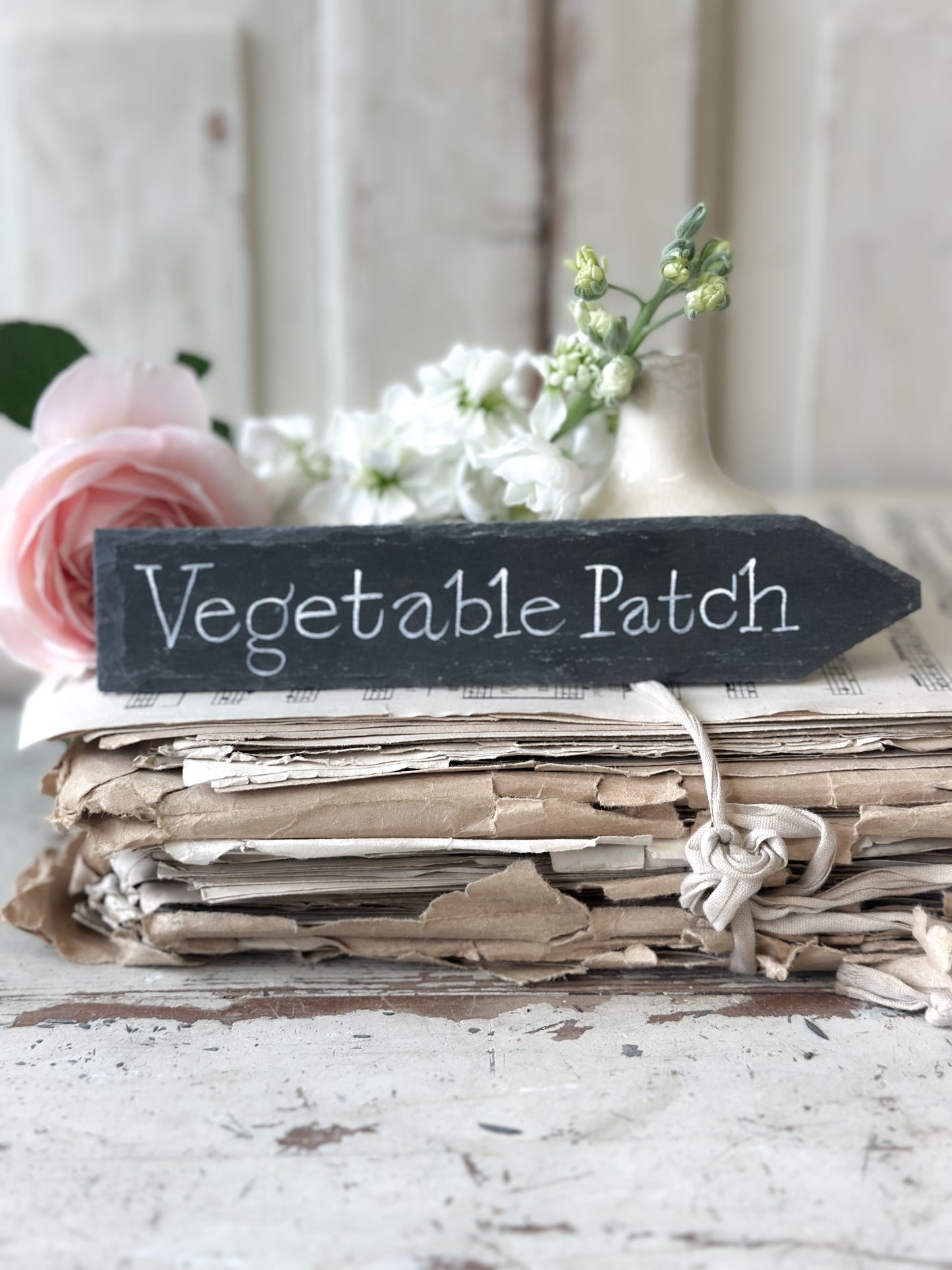 A small hand painted Victorian Welsh slate sign in lower case “Vegetable Patch”