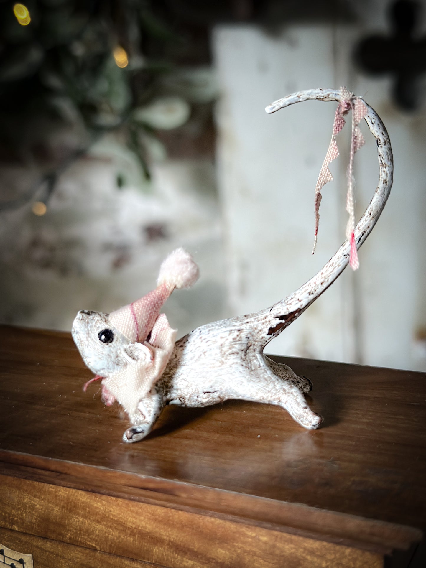 A cold painted brass “night before Christmas mouse” with a fabric ruffle and Christmas hat