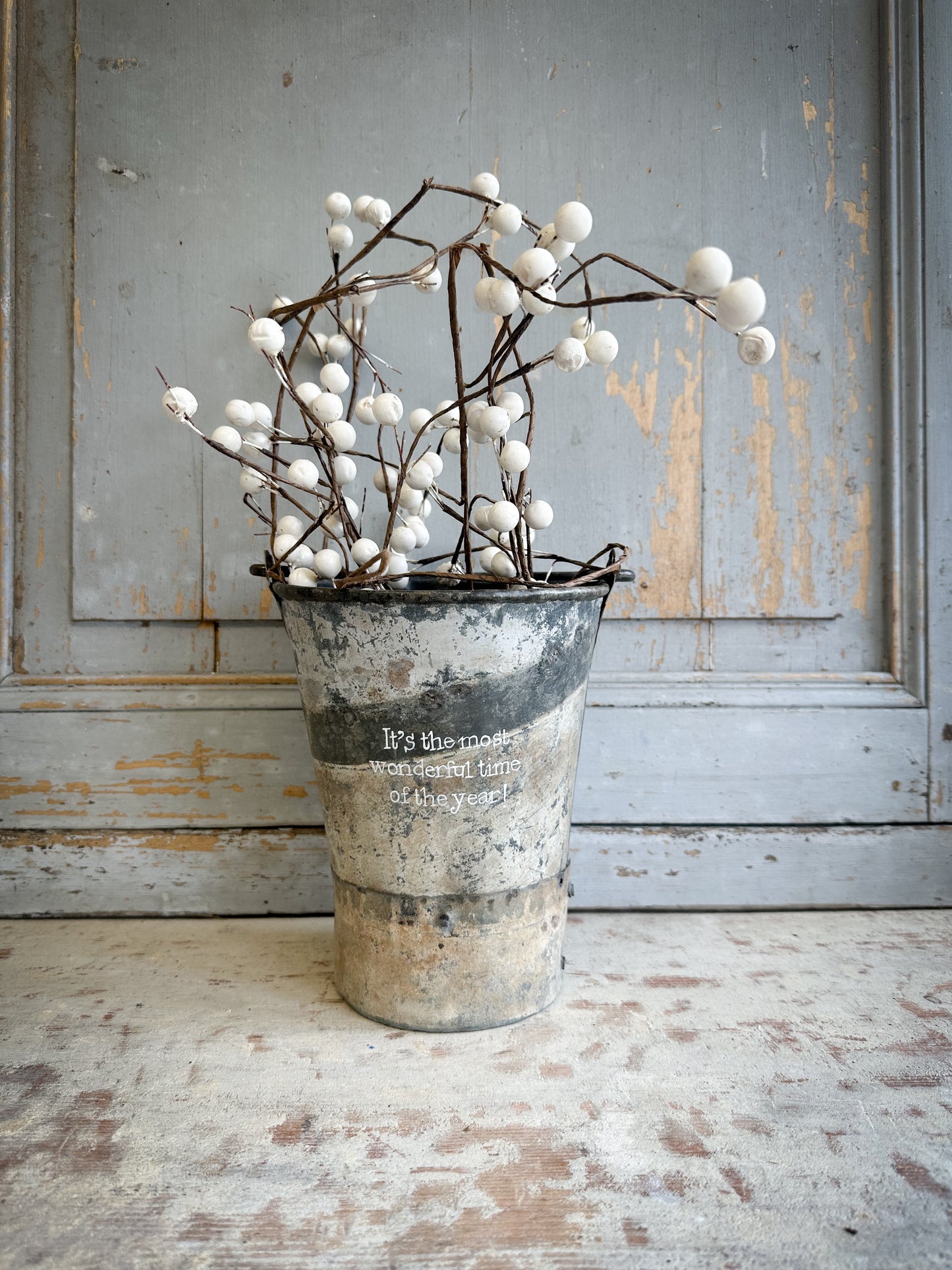 A Recycled Metal Mini Christmas Tree Bucket With A Hand Painted Quote