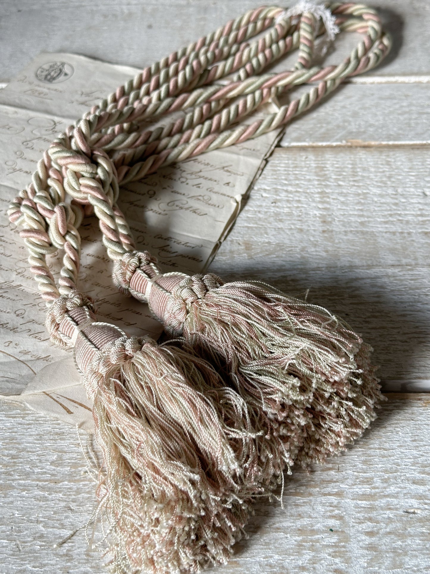 A pair of pretty vintage pastel pink, sage green and ivory curtain tie backs