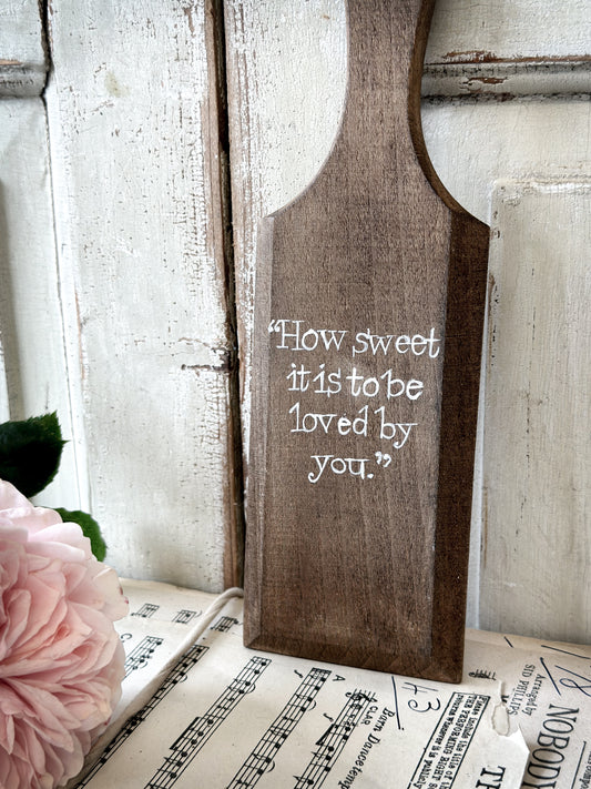 A hand painted vintage wooden butter pat “How sweet it is”