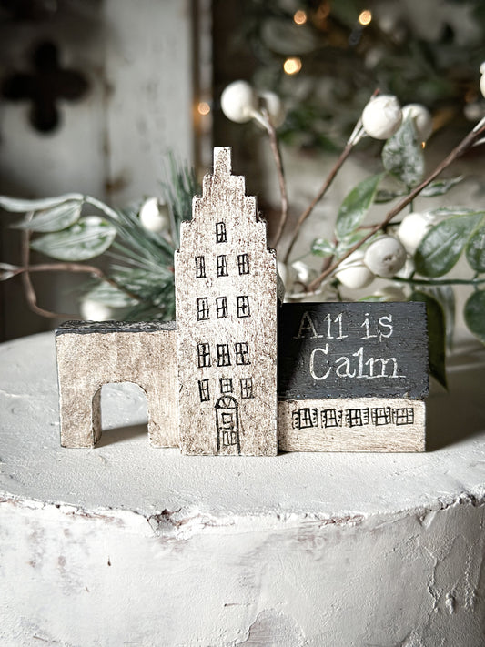 A pretty vintage German Erzgebirge Putz wooden village house painted with a Christmas quote