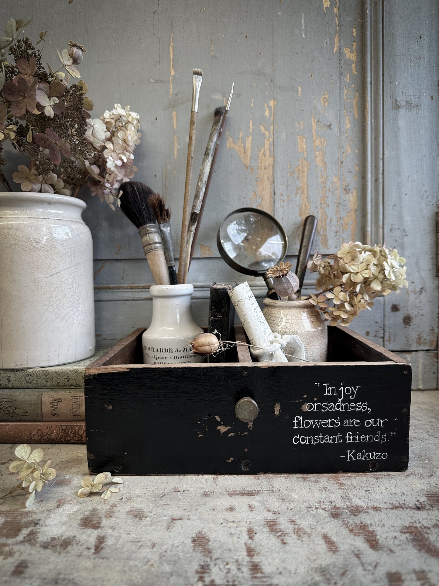 A Vintage Wooden Drawer With Hand Painted Quote