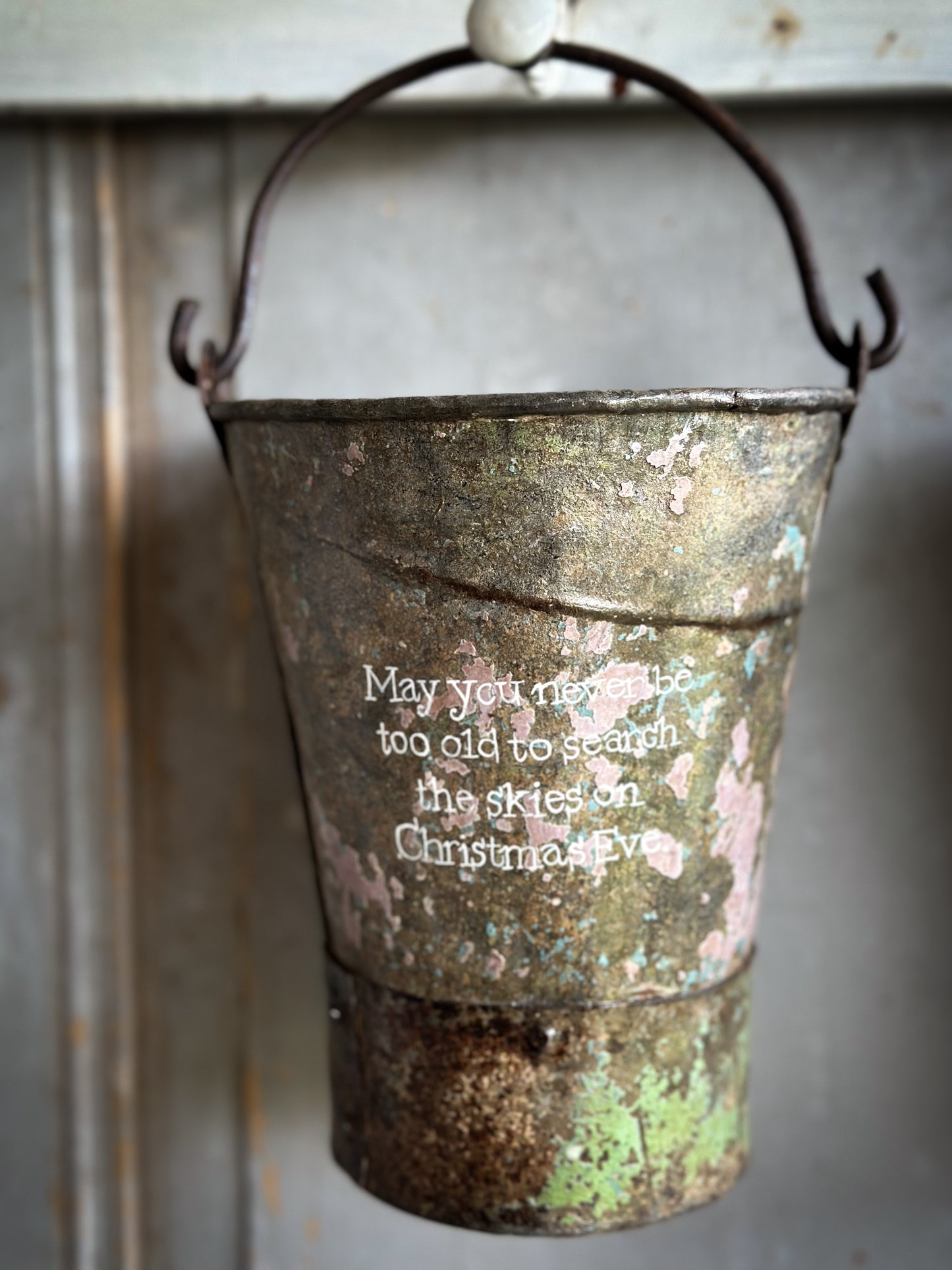 A Recycled Metal Mini Christmas Tree Bucket With A Hand Painted Quote