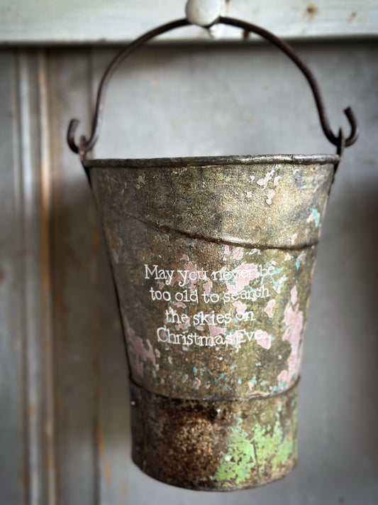A Recycled Metal Mini Christmas Tree Bucket With A Hand Painted Quote