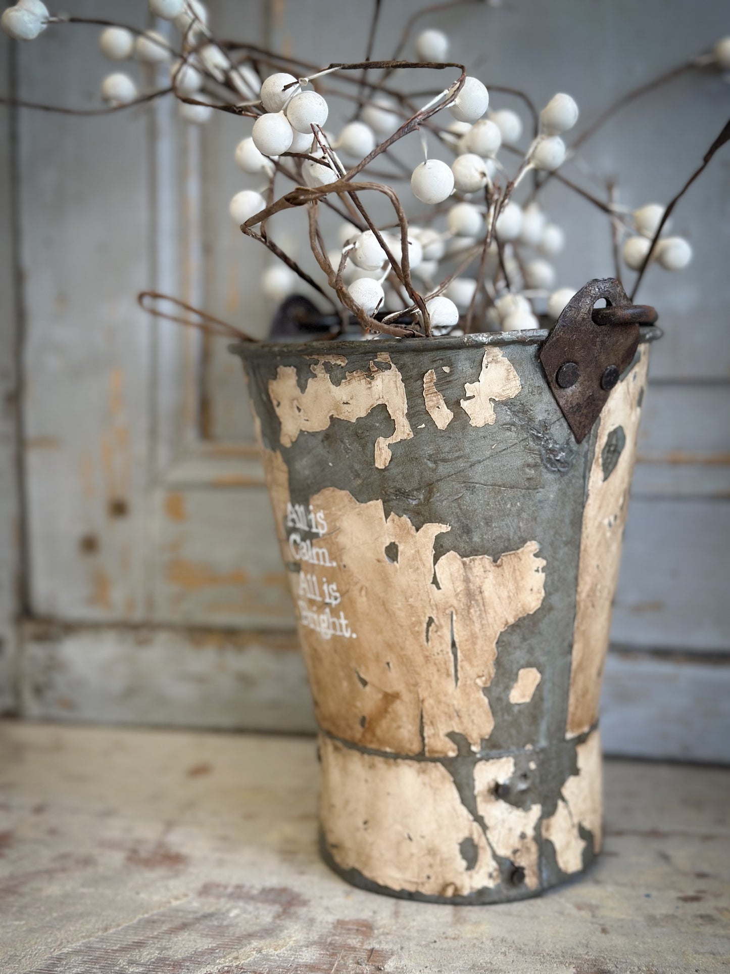 A Recycled Metal Mini Christmas Tree Bucket With A Hand Painted Quote
