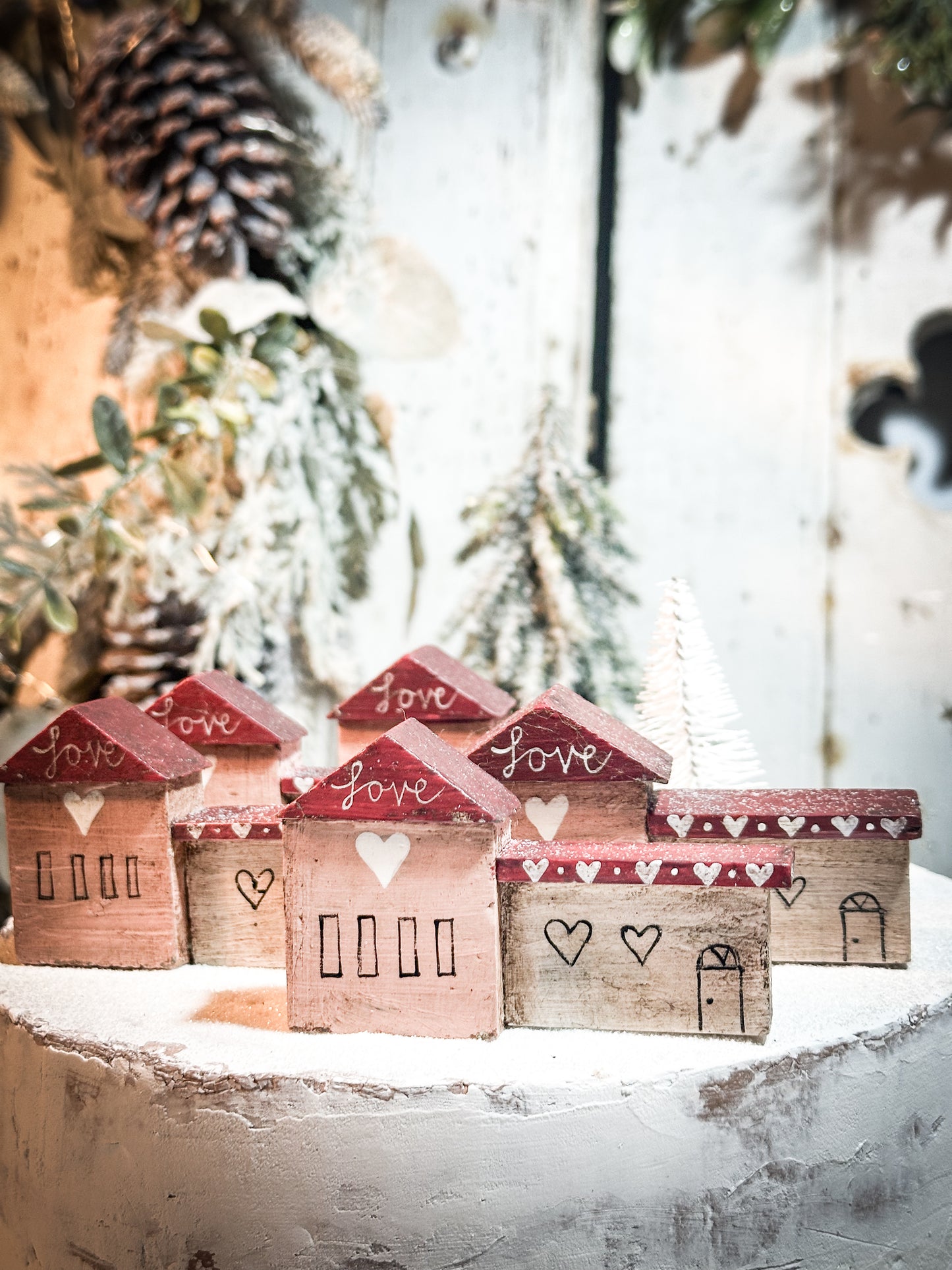 A pretty vintage German Erzgebirge Putz wooden village house painted with a Christmas quote