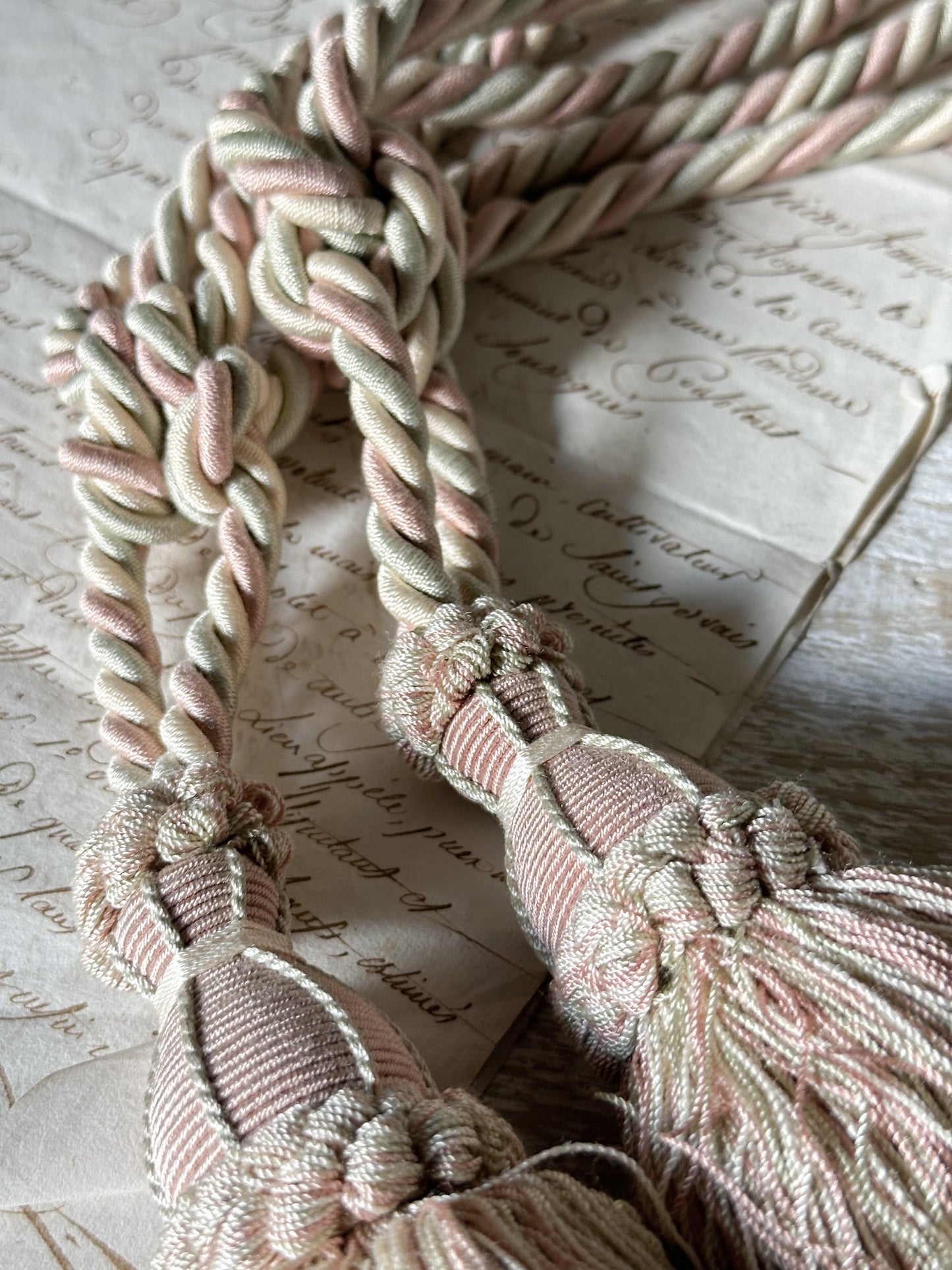 A pair of pretty vintage pastel pink, sage green and ivory curtain tie backs