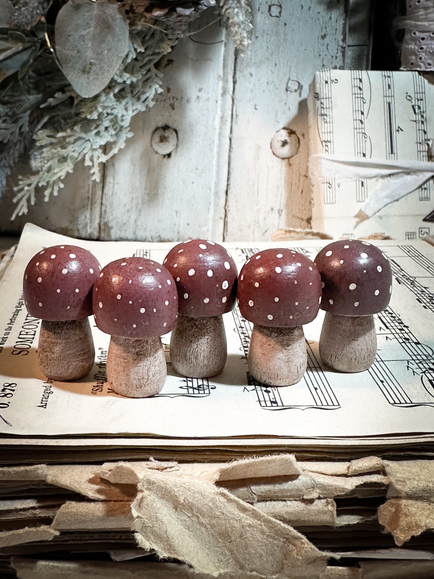 A wooden hand painted Christmas village toadstool