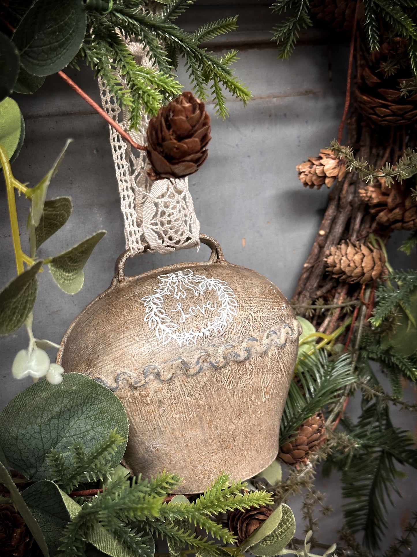 A Large Vintage Painted Cow Bell With a Hand Painted Quote