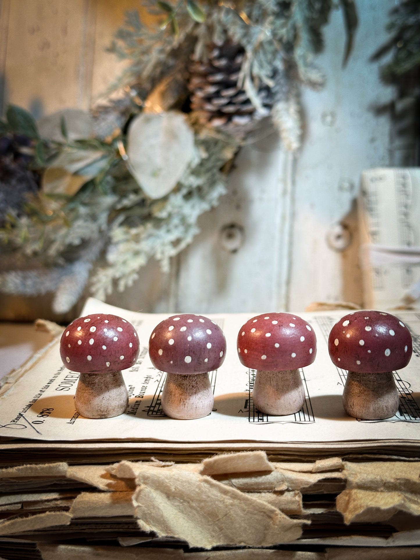 A wooden hand painted Christmas village toadstool