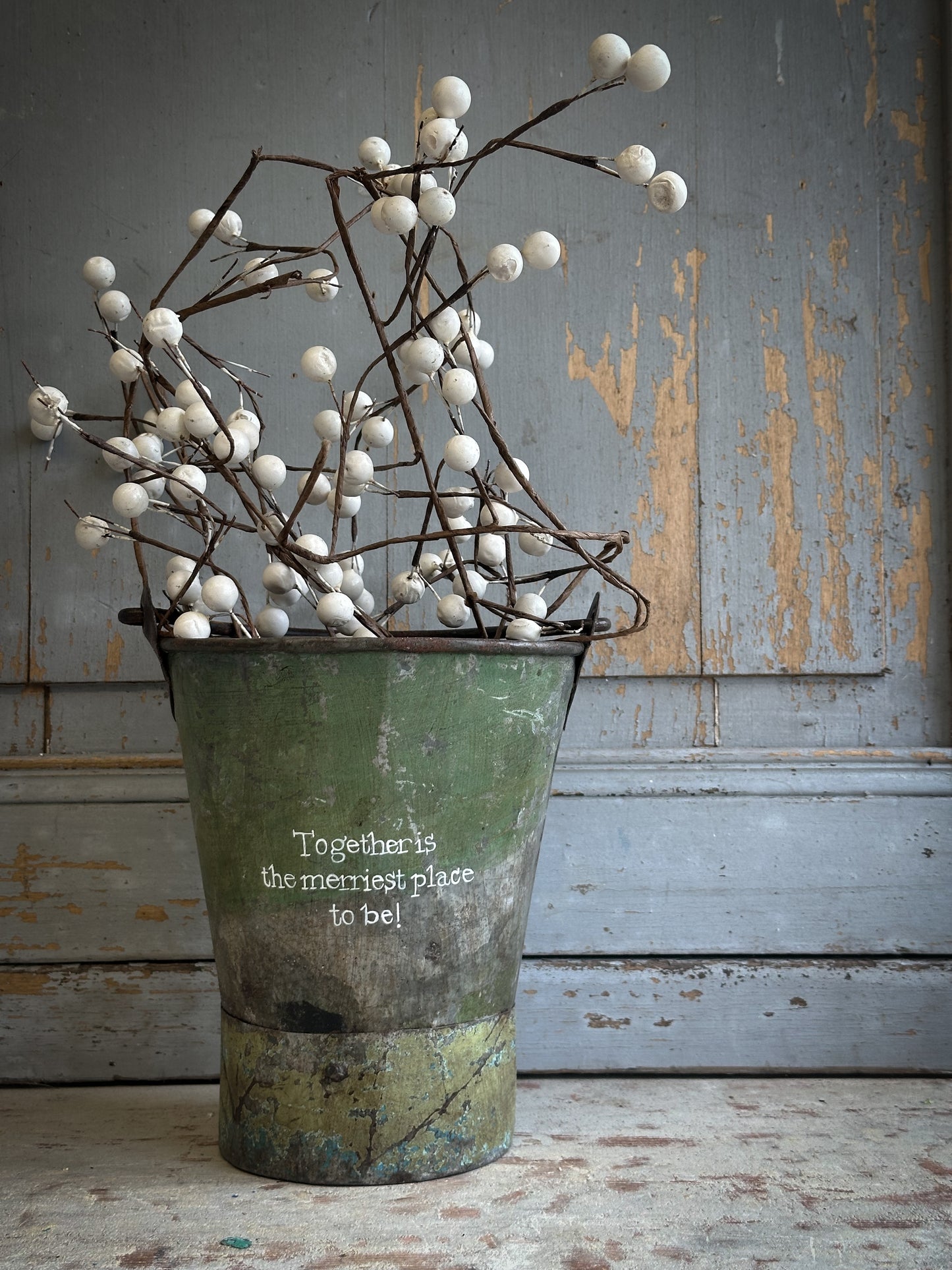 A Recycled Metal Mini Christmas Tree Bucket With A Hand Painted Quote