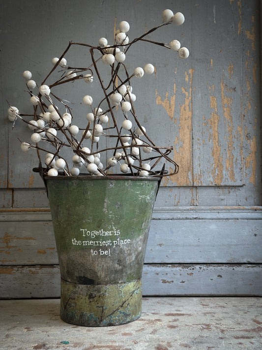A Recycled Metal Mini Christmas Tree Bucket With A Hand Painted Quote
