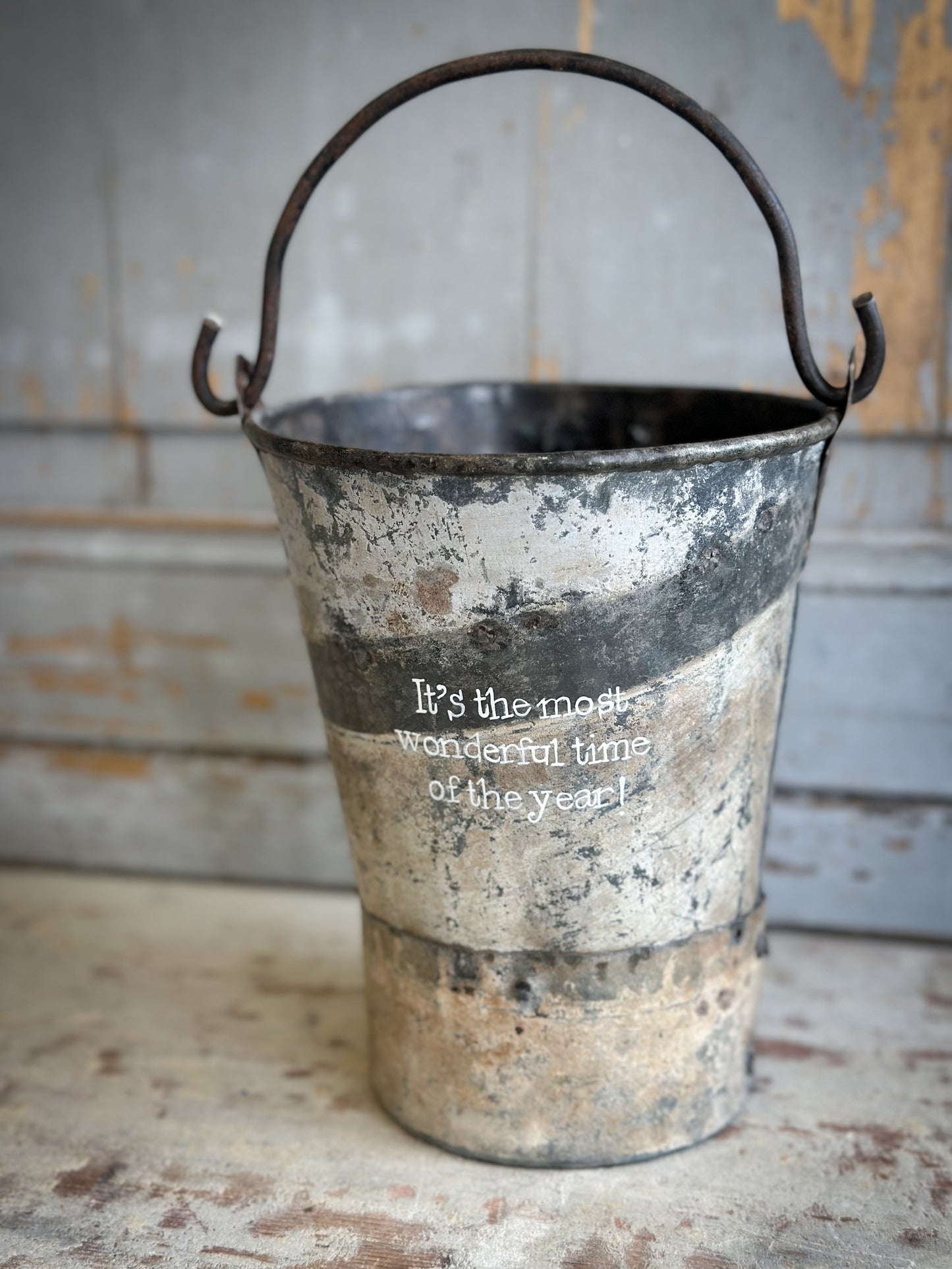 A Recycled Metal Mini Christmas Tree Bucket With A Hand Painted Quote