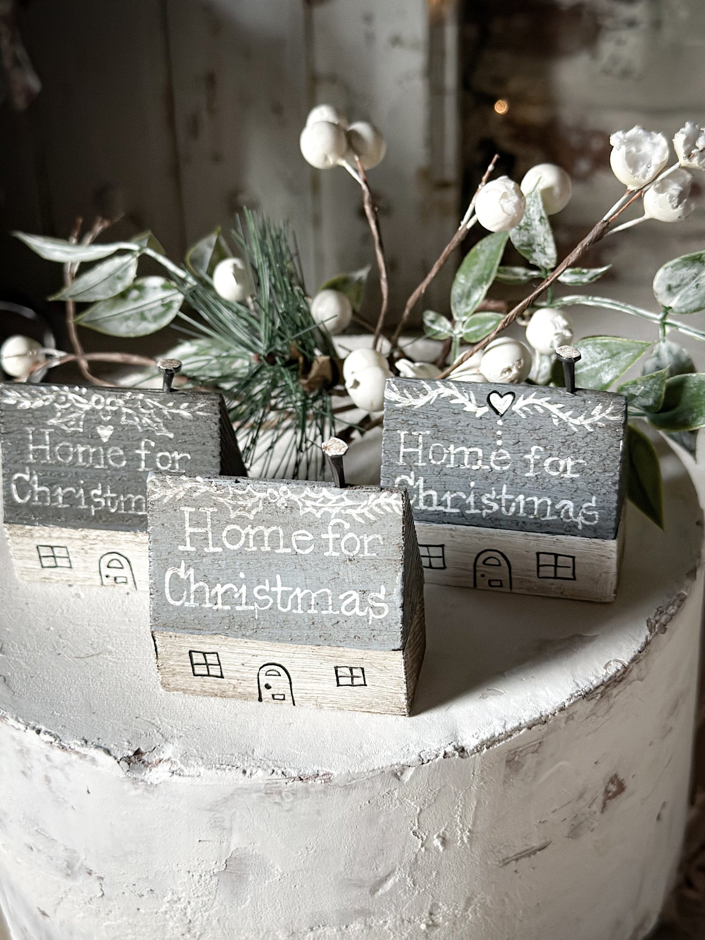 A pretty vintage German Erzgebirge Putz wooden village house painted with a Christmas quote