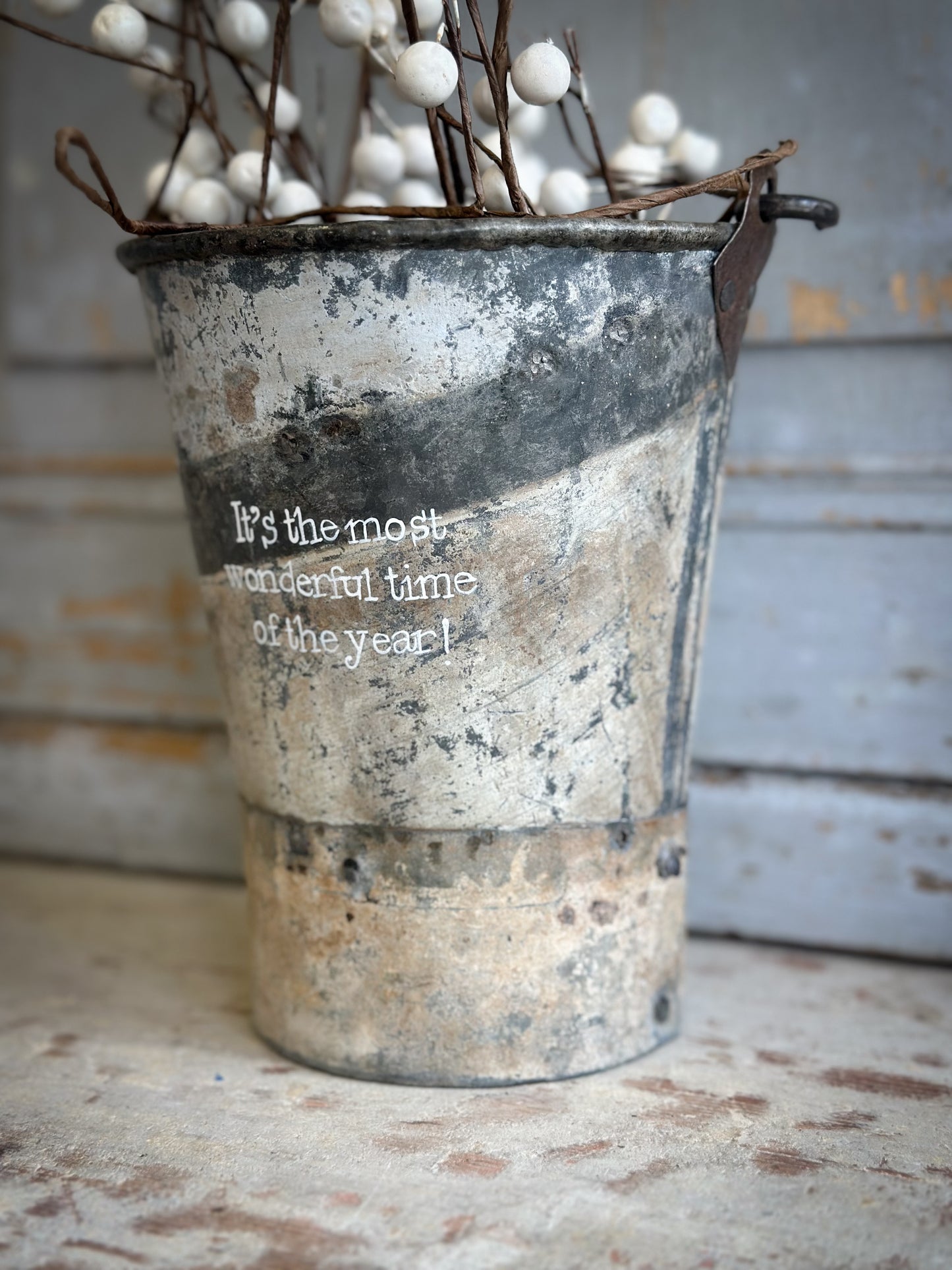 A Recycled Metal Mini Christmas Tree Bucket With A Hand Painted Quote
