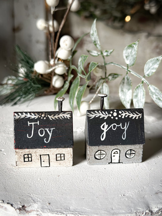 A pretty vintage German Erzgebirge Putz wooden village house painted with a Christmas quote