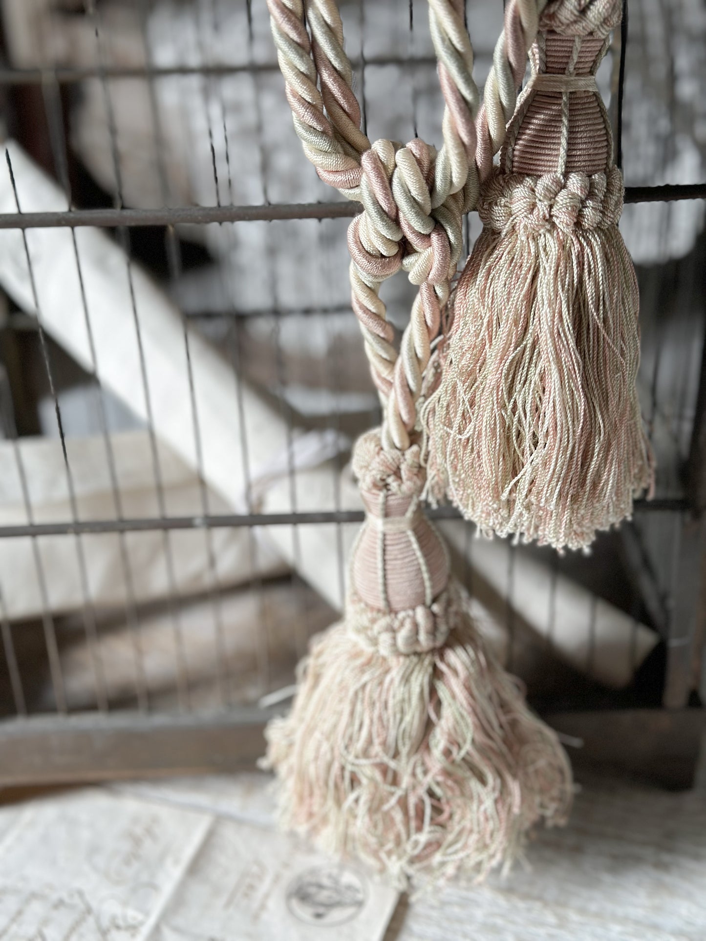 A pair of pretty vintage pastel pink, sage green and ivory curtain tie backs