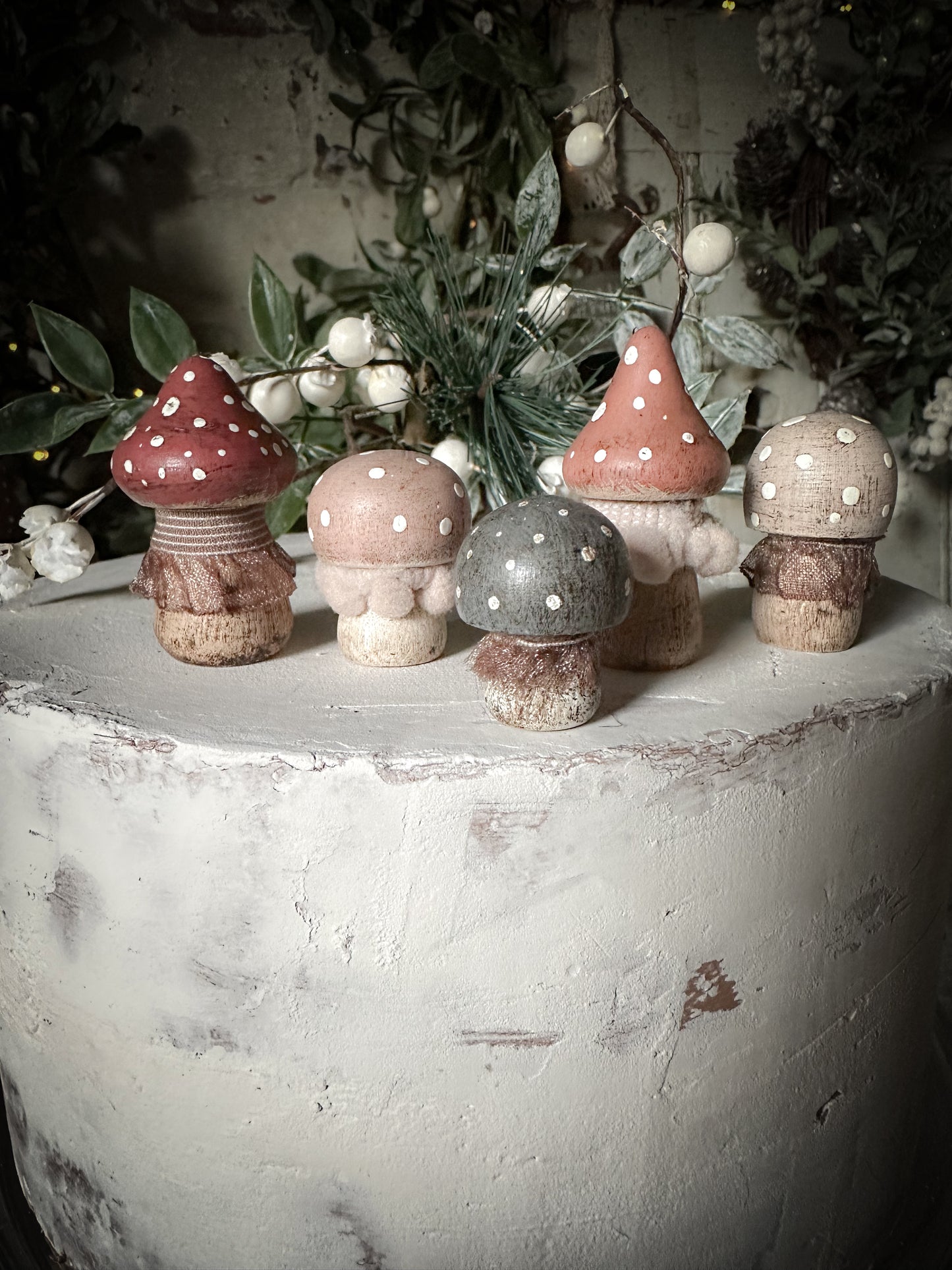 A set of five wooden hand painted and trimmed Christmas village toadstools