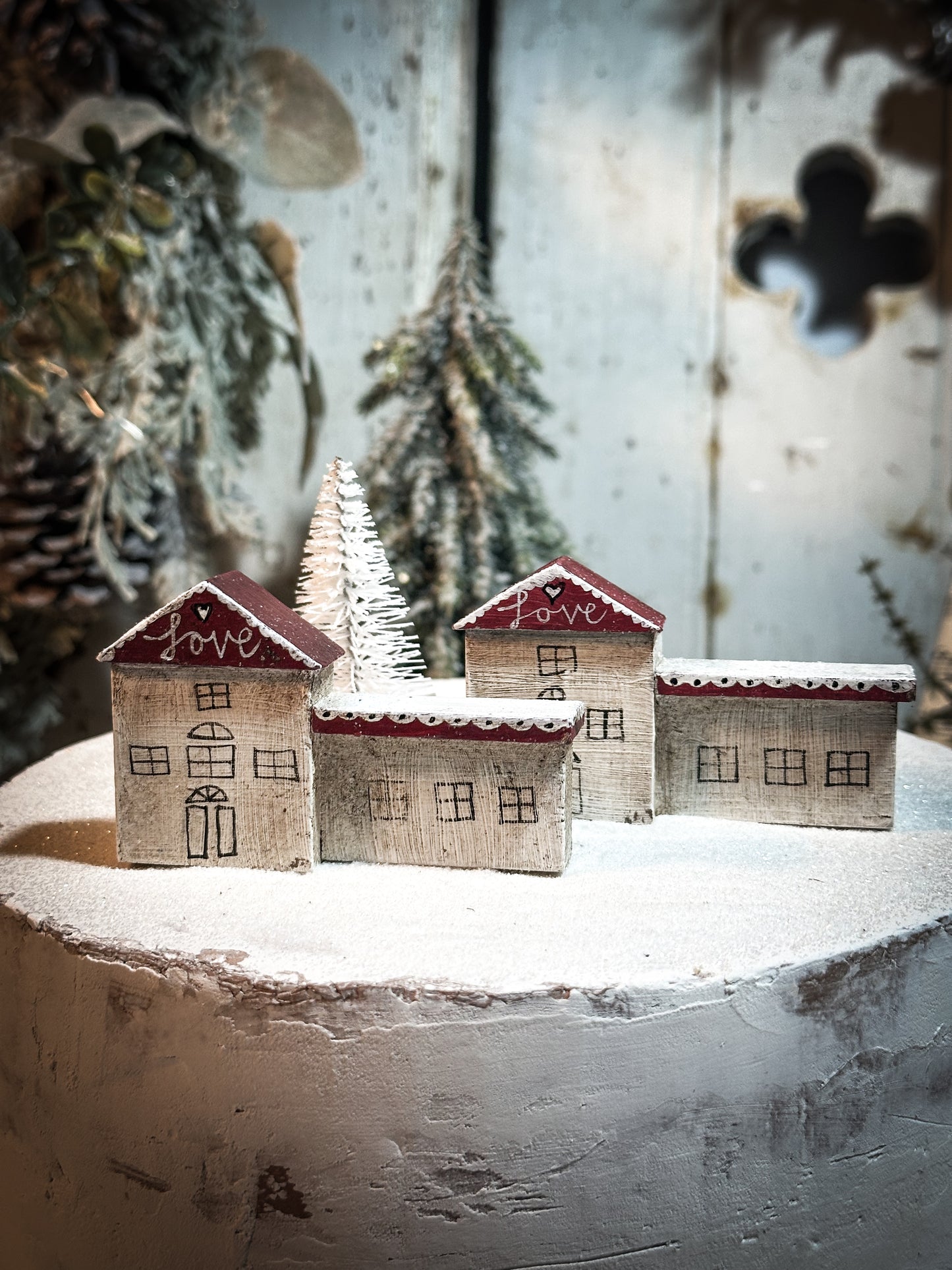 A pretty vintage German Erzgebirge Putz wooden village house painted with a Christmas quote