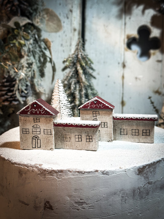 A pretty vintage German Erzgebirge Putz wooden village house painted with a Christmas quote