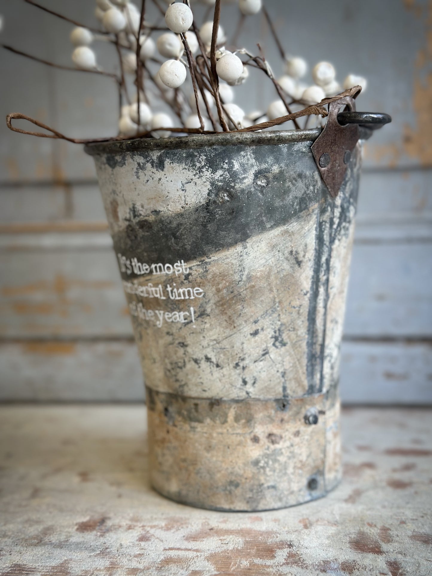 A Recycled Metal Mini Christmas Tree Bucket With A Hand Painted Quote