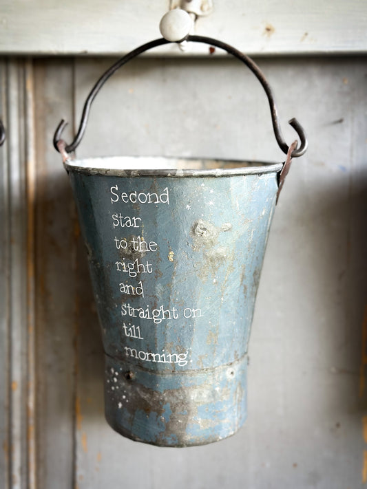 A Recycled Metal Mini Christmas Tree Bucket With A Hand Painted Quote