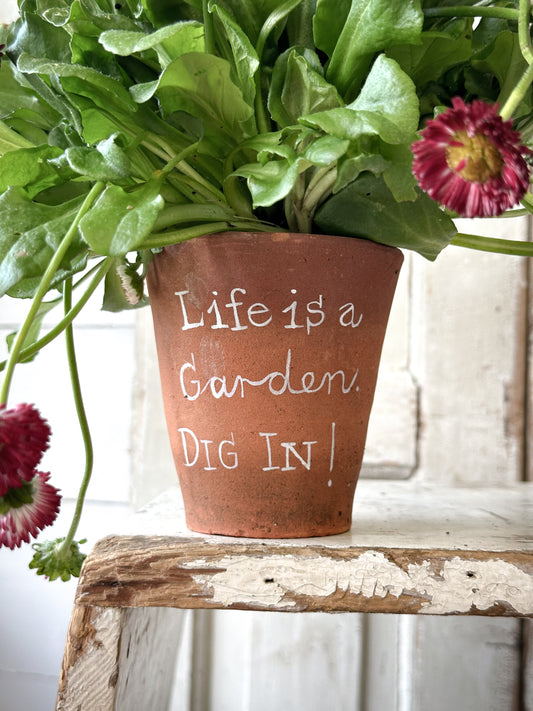 A Victorian terracotta pot with a quote “Life is a Garden”