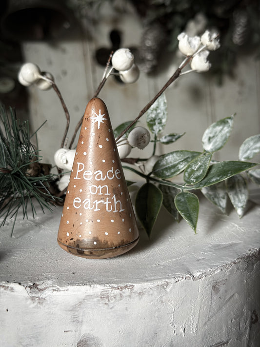 A hand painted quote on a lignum vitae wood plumber’s turnpin with a Christmas quote