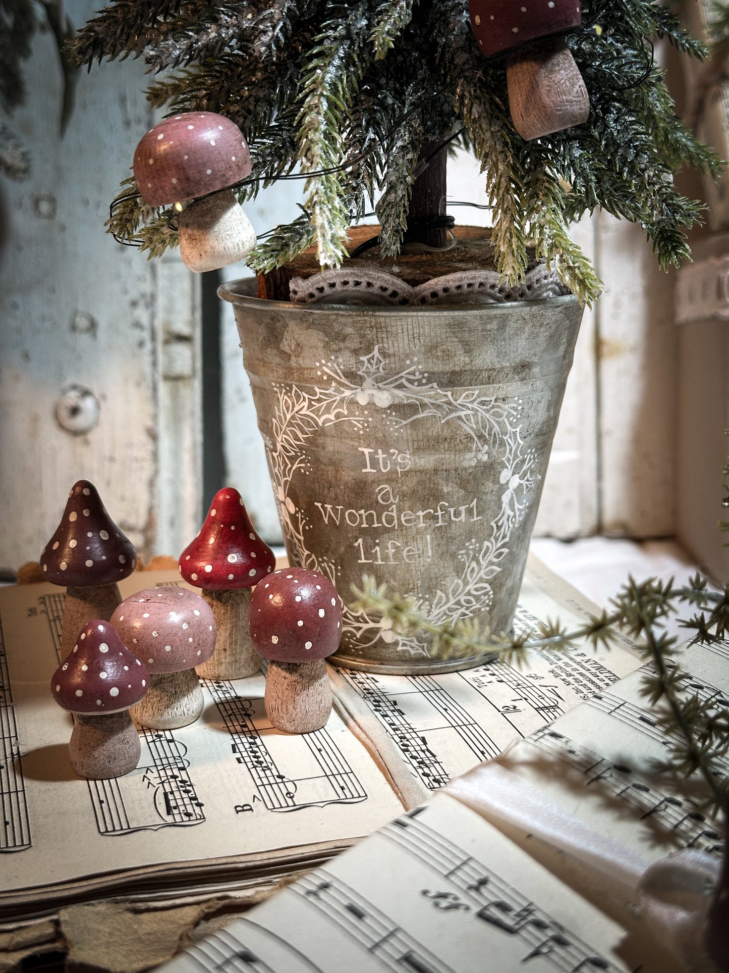 A wooden hand painted Christmas village toadstool